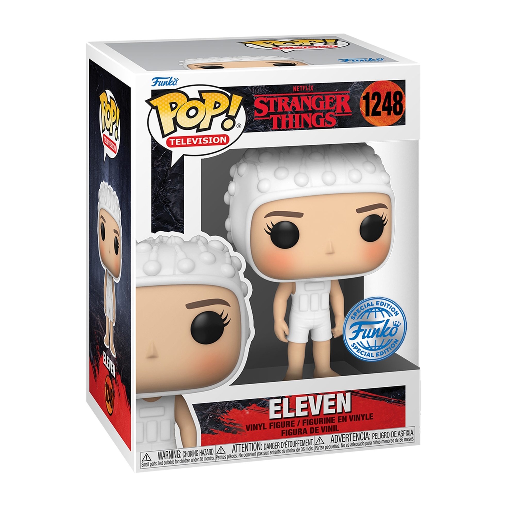 Elf Figur in einer Box. Weißes Outfit, kurze Haare und ausdrucksloser Gesichtsausdruck.