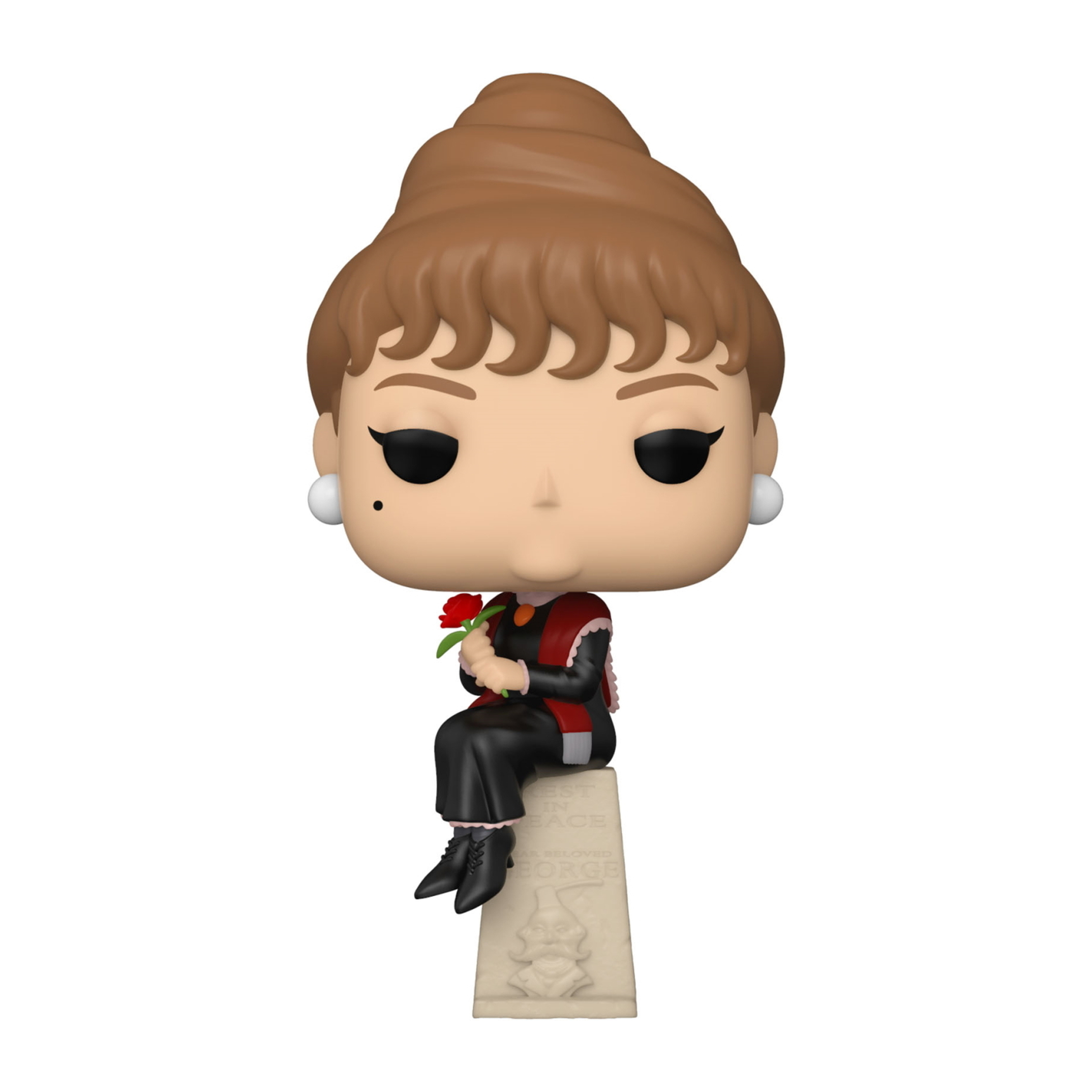 Audrey Hepburn Figur, die auf einem Stein sitzt. Sie trägt Schwarz und hält eine rote Rose.