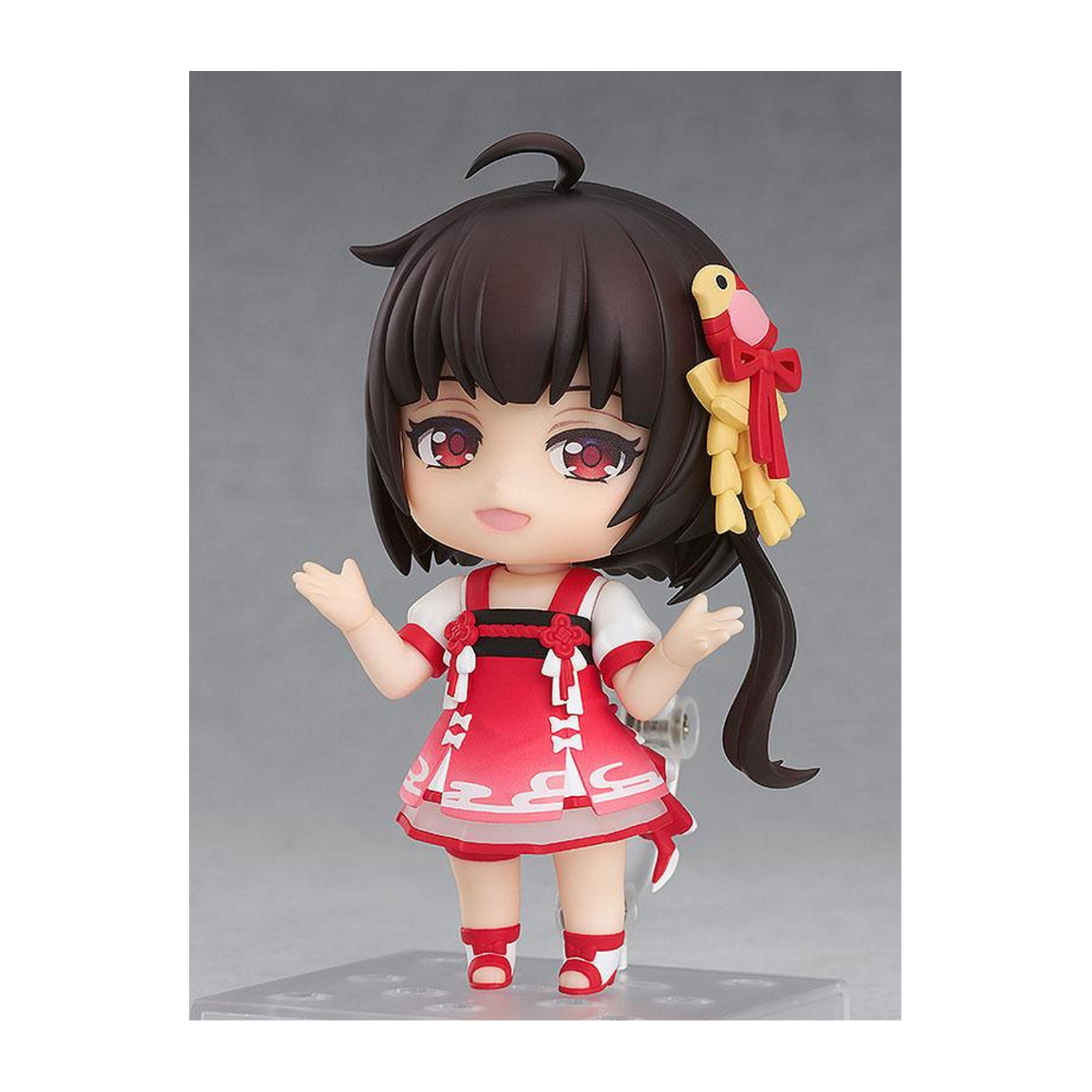 Chibi-Anime-Mädchen mit dunklen Haaren und roten Augen. Sie trägt ein rot-weißes Kleid mit Schleife.