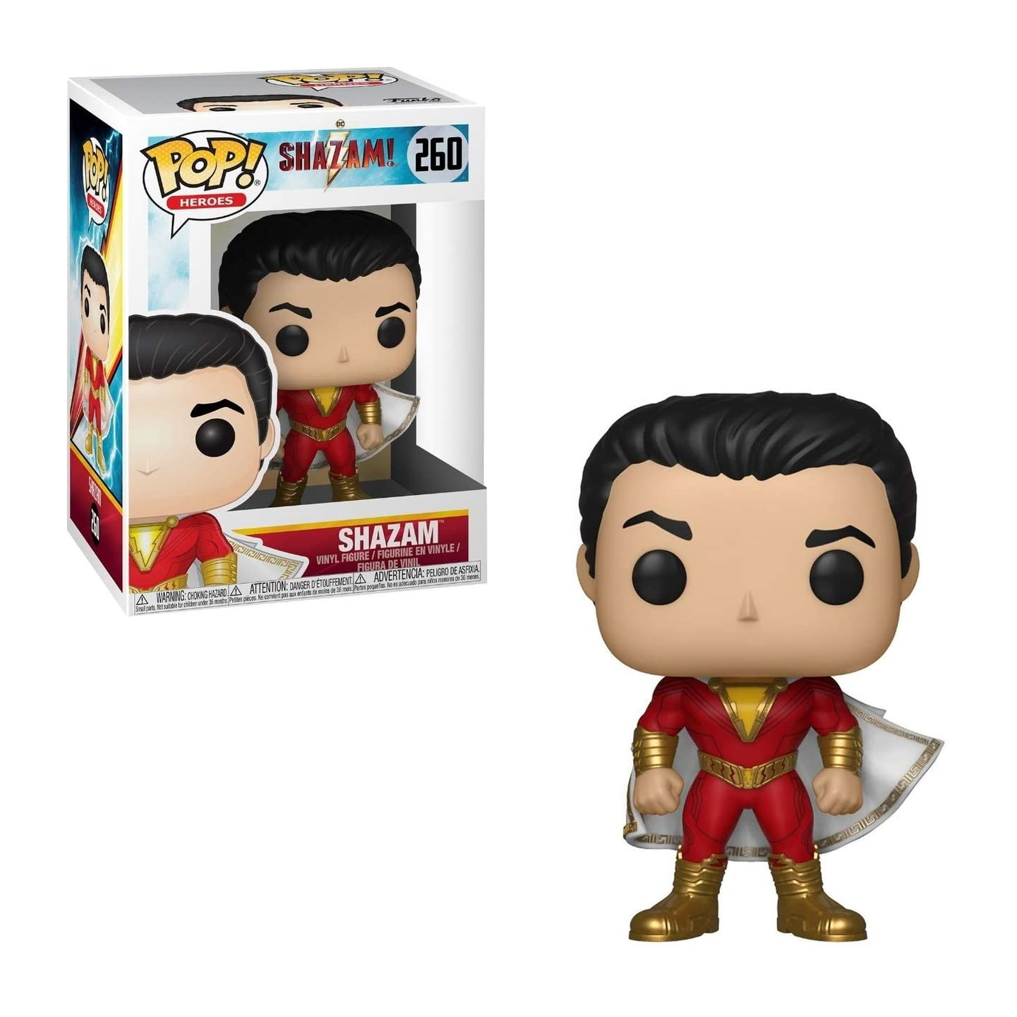 Figura di Shazam in abito rosso e oro. Ha i capelli neri e un mantello bianco. La scatola è dietro.