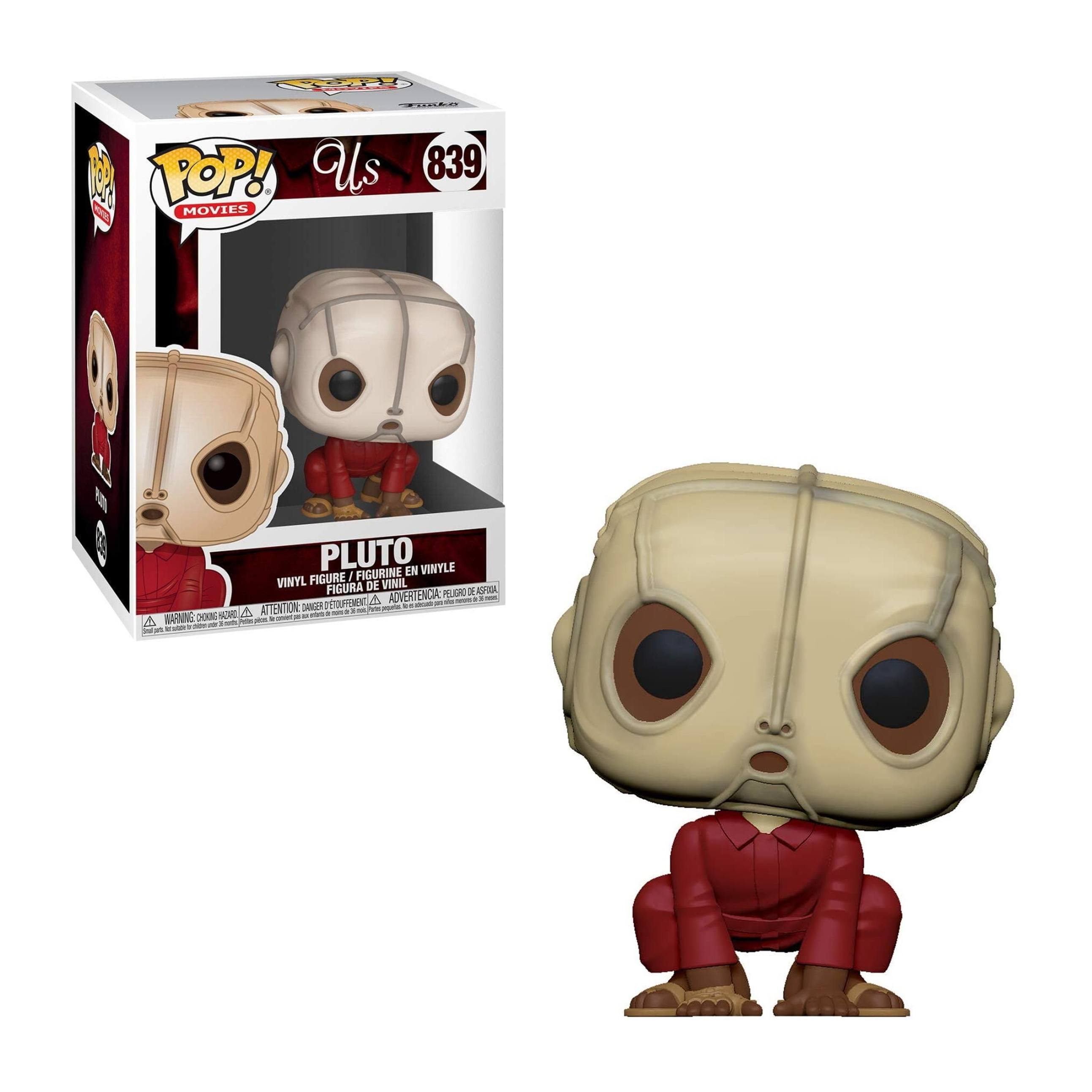 Figura de Pluto de la película 'Nosotros', con una caja que muestra el personaje, en un mono rojo, sobre un fondo blanco.