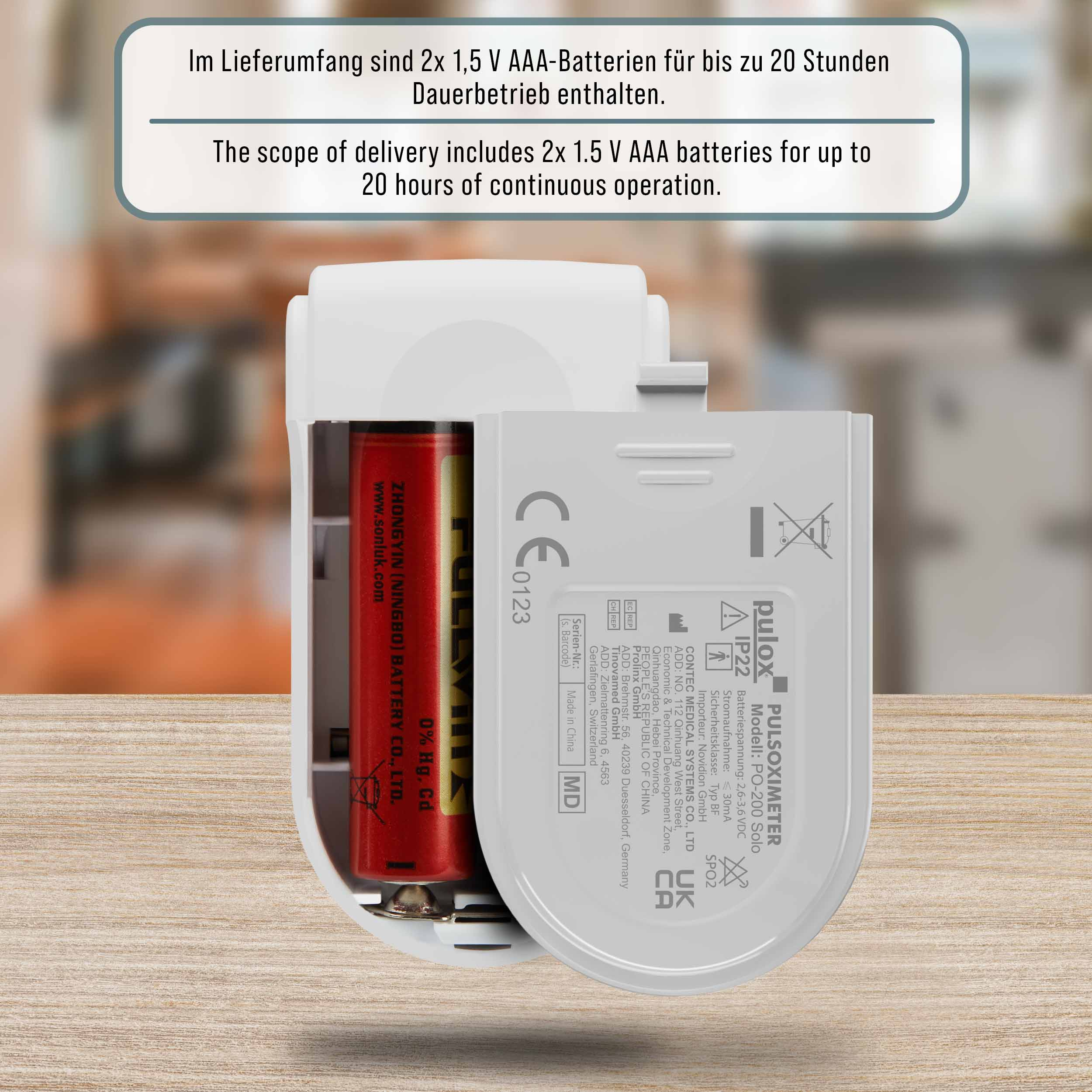 Gerät mit roter Batterie, weißes Gehäuse, Text auf Englisch und Deutsch.