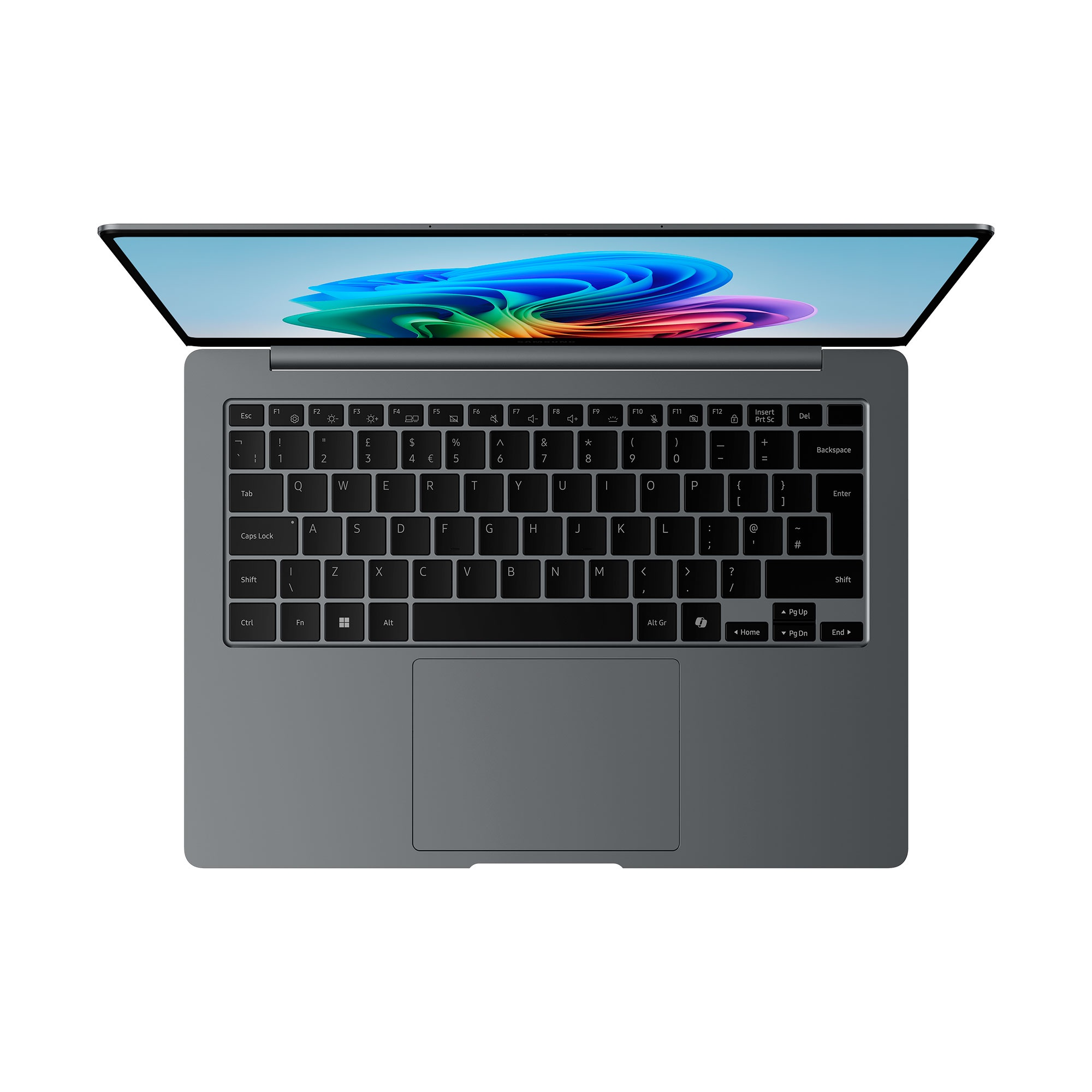 Un portátil gris con la pantalla abierta, mostrando un teclado. El portátil está sobre una superficie blanca.