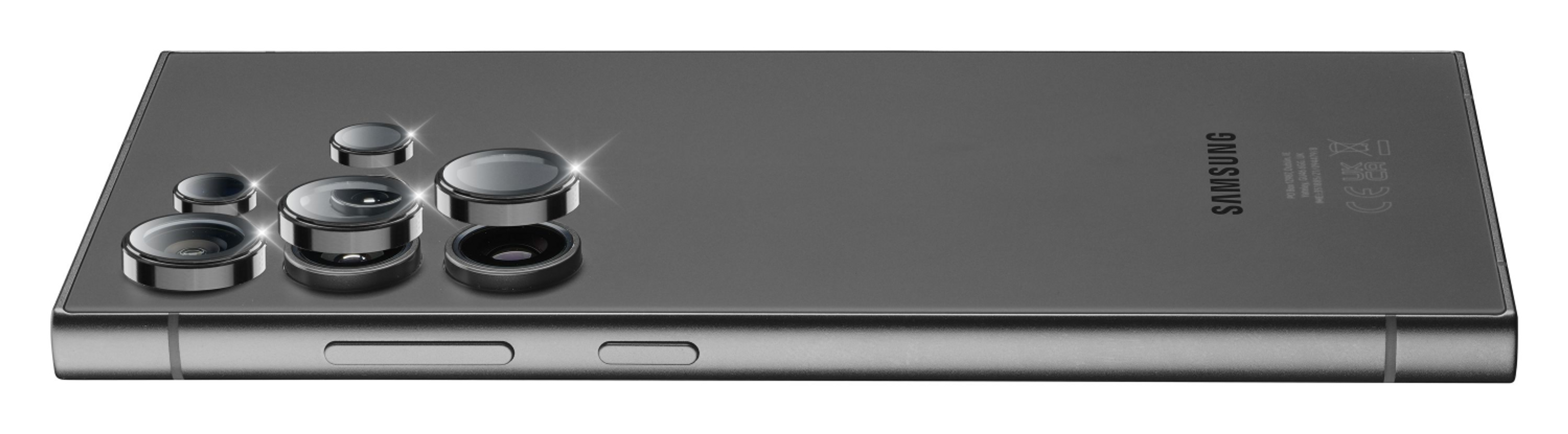 Zbliżenie tylnej części szarego smartfona. Widoczne są obiektywy aparatu.