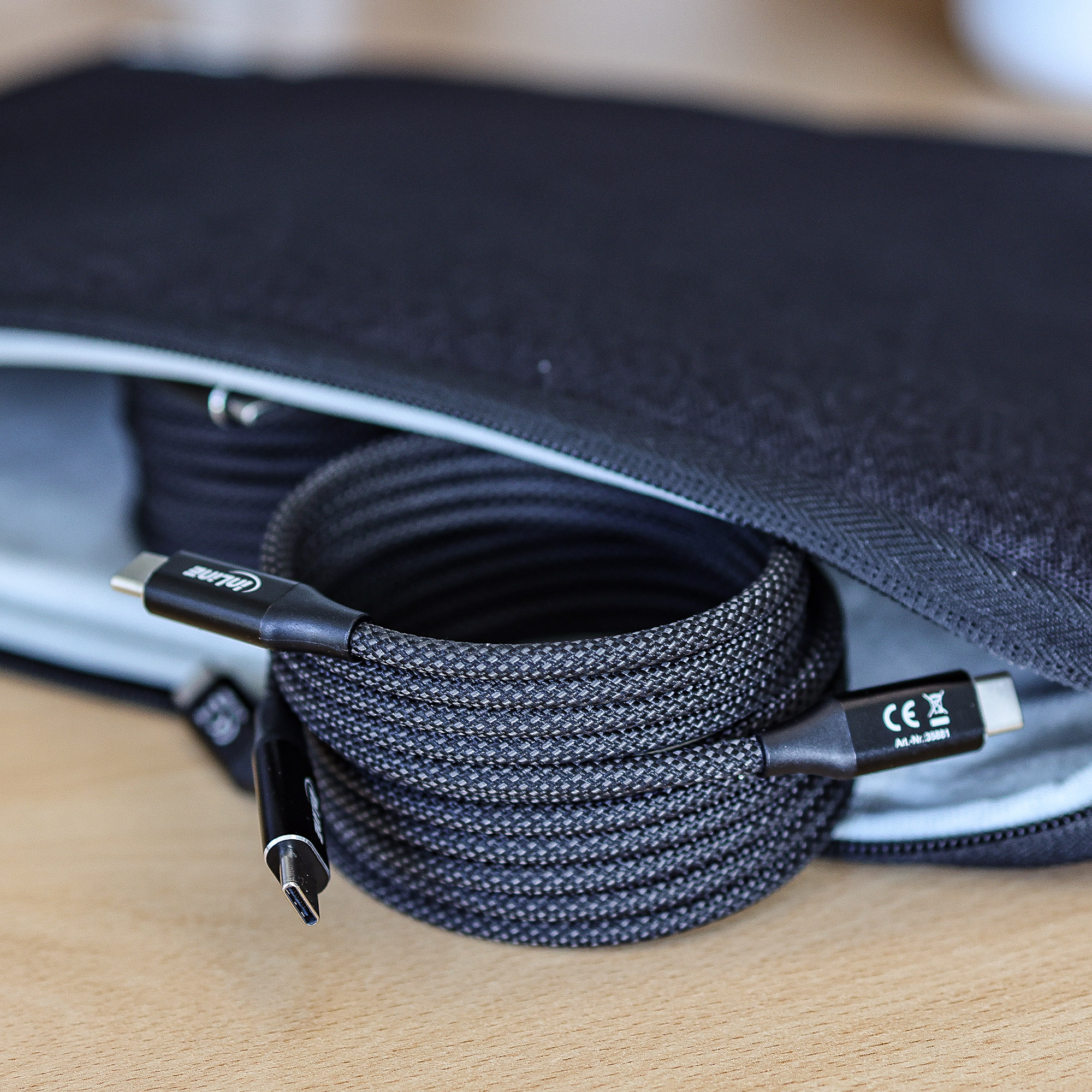 Câble USB-C noir enroulé dans un étui noir.