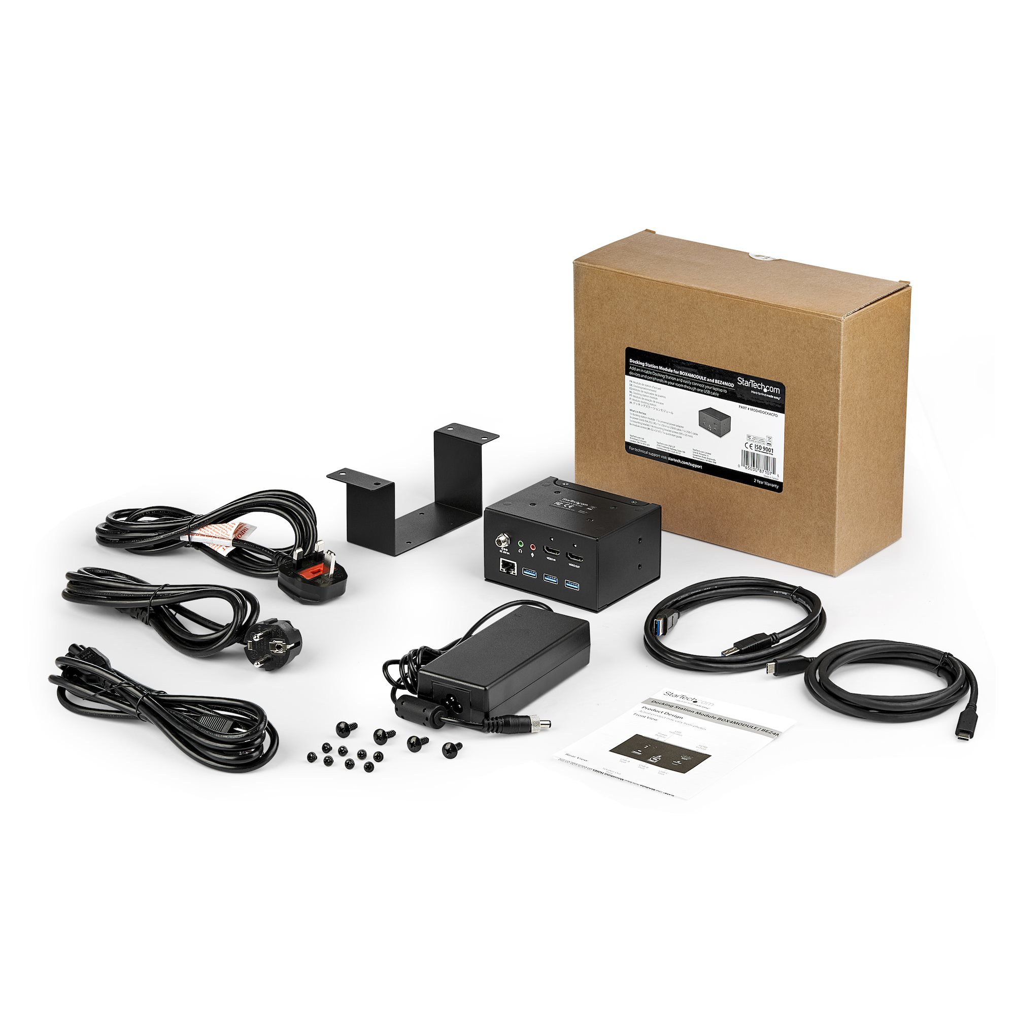 Karton mit Elektronik und Zubehör. Kabel, Netzteil und Montagehalterungen sind sichtbar.