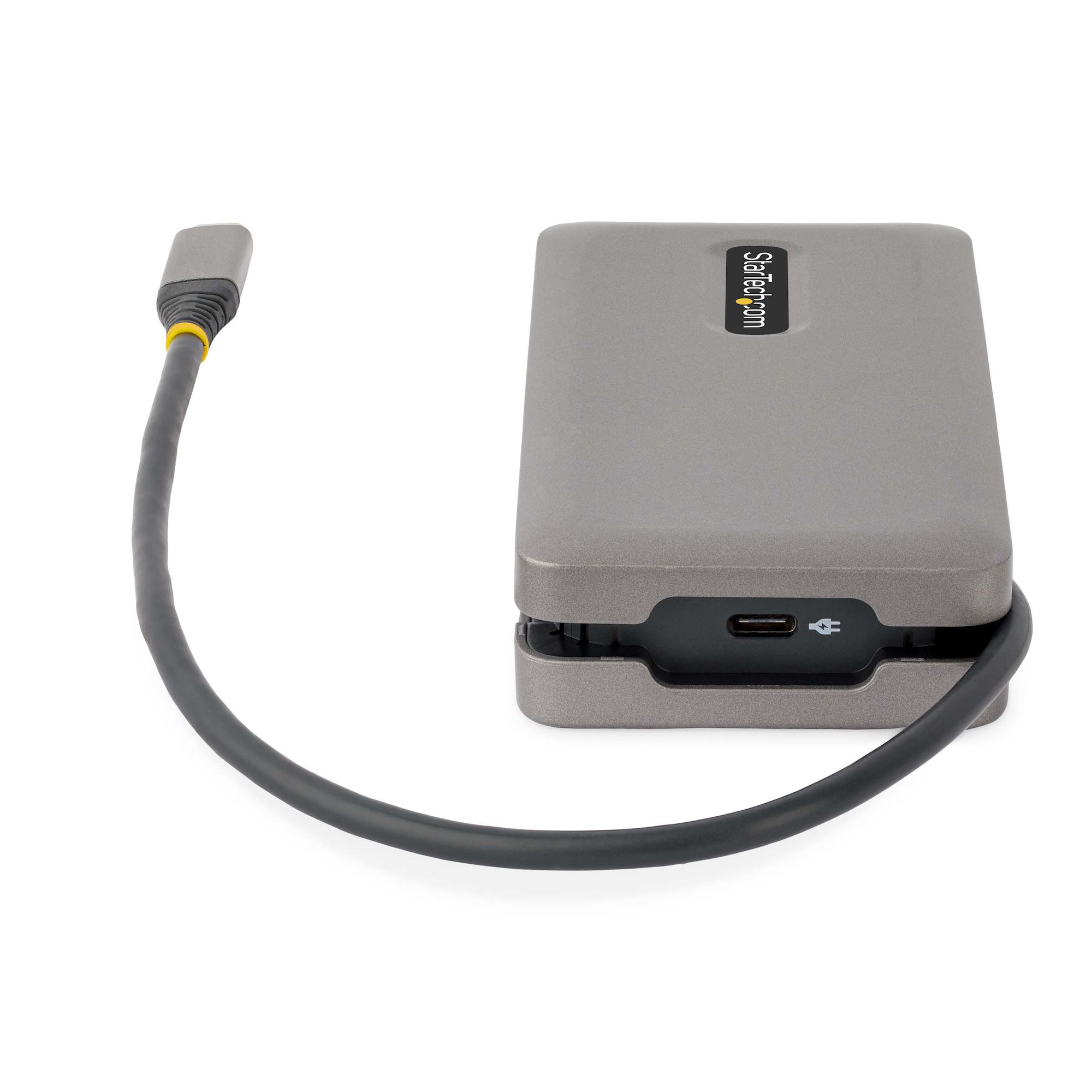Un disco rigido esterno grigio Startech.com con cavo nero e connettore giallo, su superficie bianca.