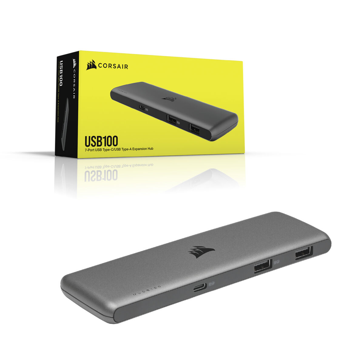 Un hub USB e una scatola. L'hub è grigio. La scatola è gialla con il marchio CORSAIR.