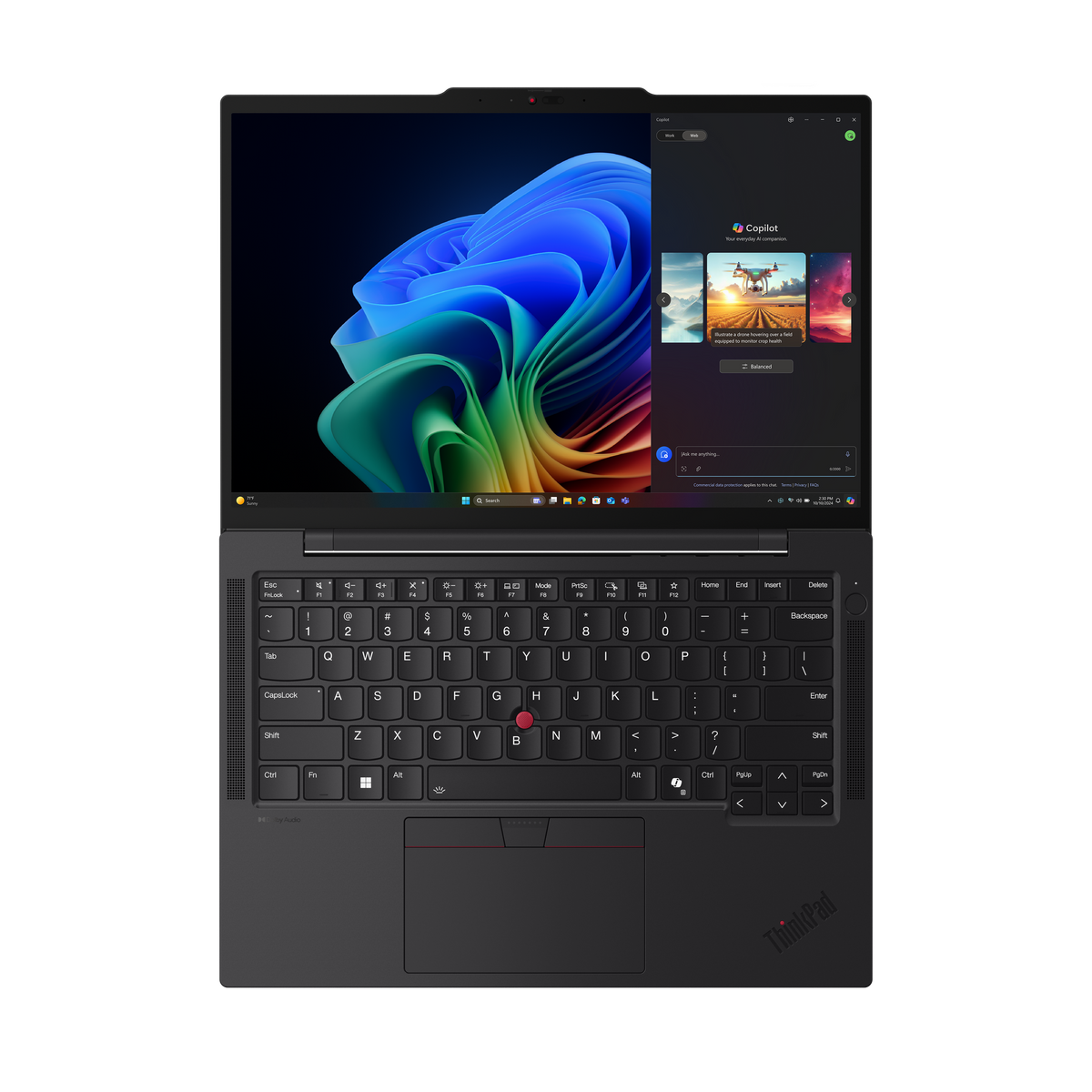Portátil abierto con pantalla y teclado coloridos, que muestra la interfaz de Copilot, sobre una superficie negra.