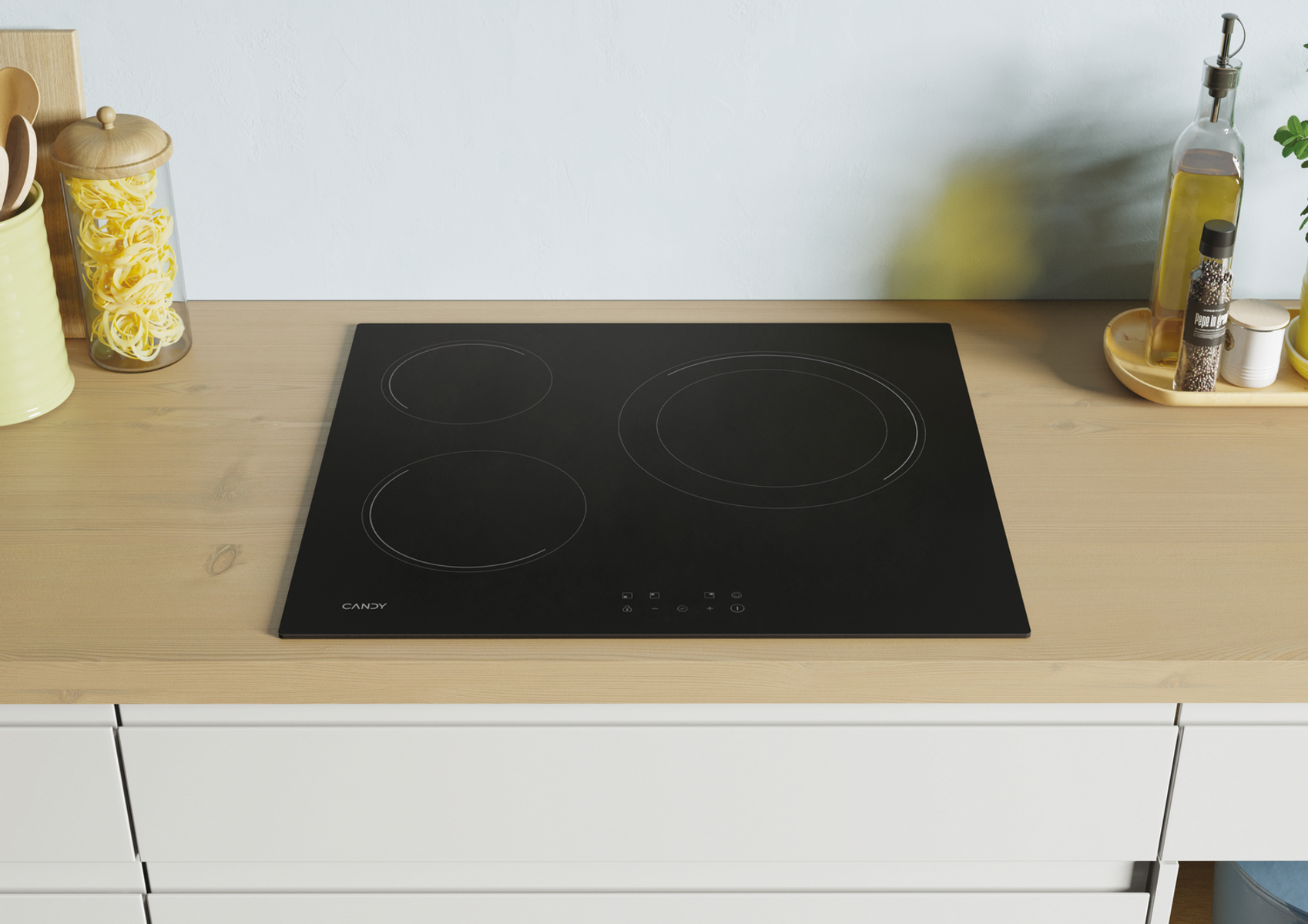 Czarna płyta indukcyjna z trzema strefami grzewczymi. Na drewnianym blacie.