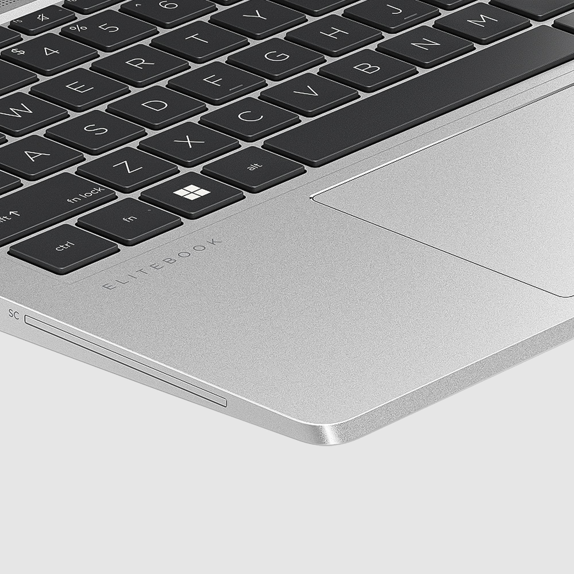Zbliżenie klawiatury i touchpada laptopa. Pokazuje klawisze, touchpad i słowo ELITEBOOK na laptopie.
