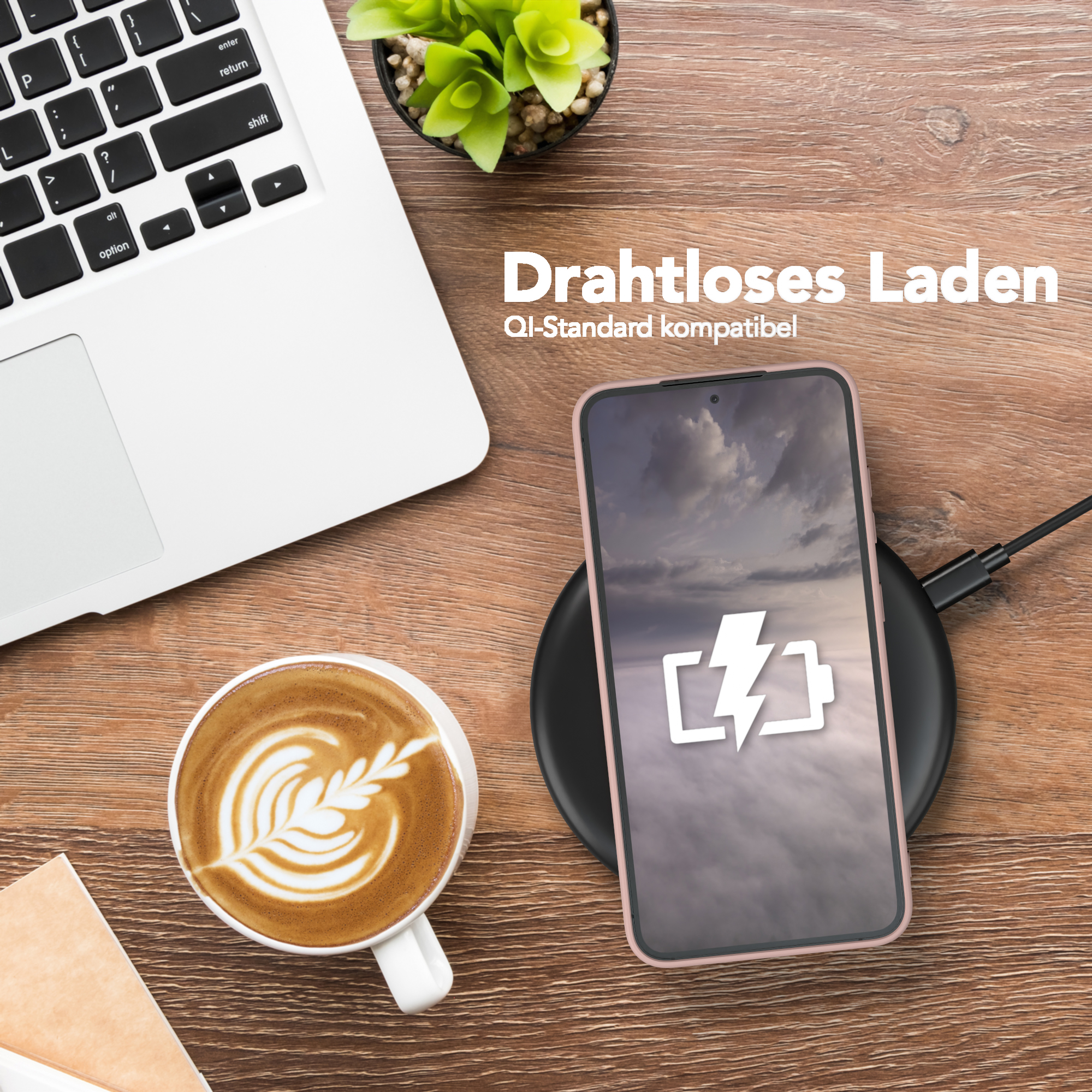 Ein Telefon wird kabellos auf einem Ladepad geladen, neben einer Kaffeetasse und einem Laptop.