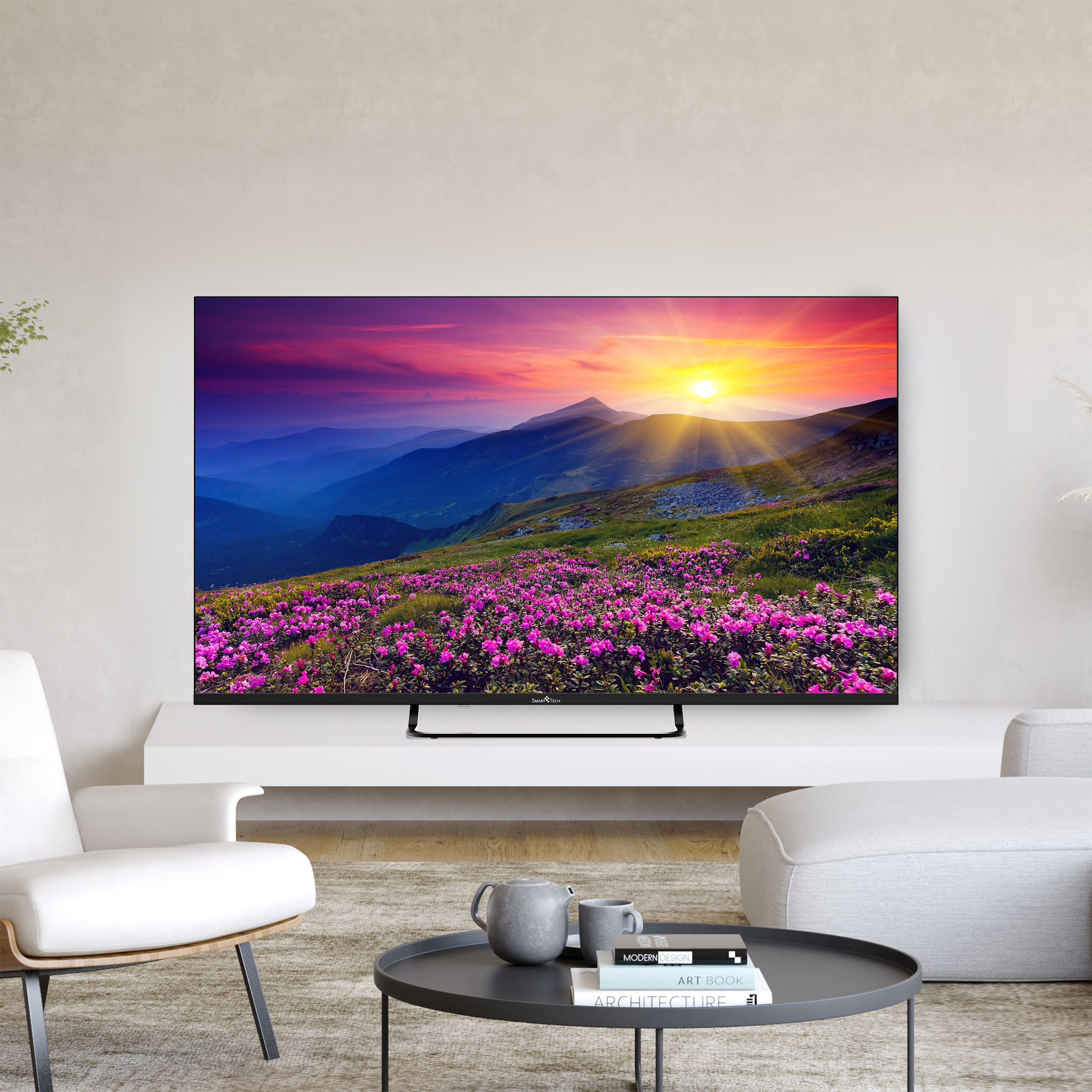 Soggiorno con TV che mostra un paesaggio. Mobili bianchi, sfondo tramonto.