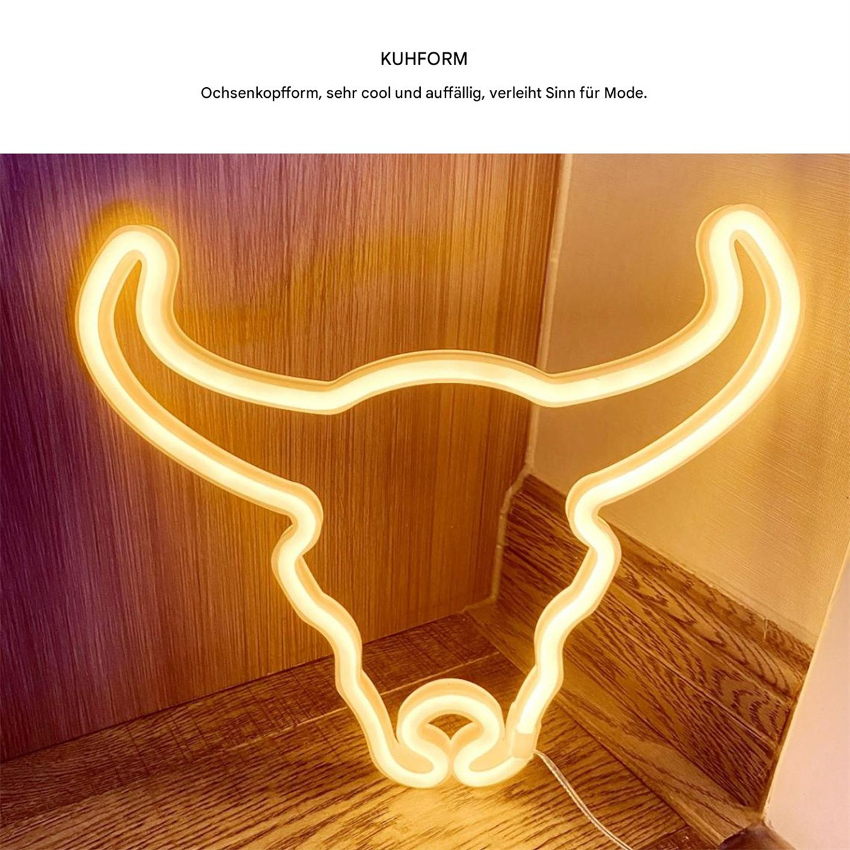 Ein Neonlicht in Form eines Bullenkopfes hängt an einer Wand. Es hat einen gelben Schein.