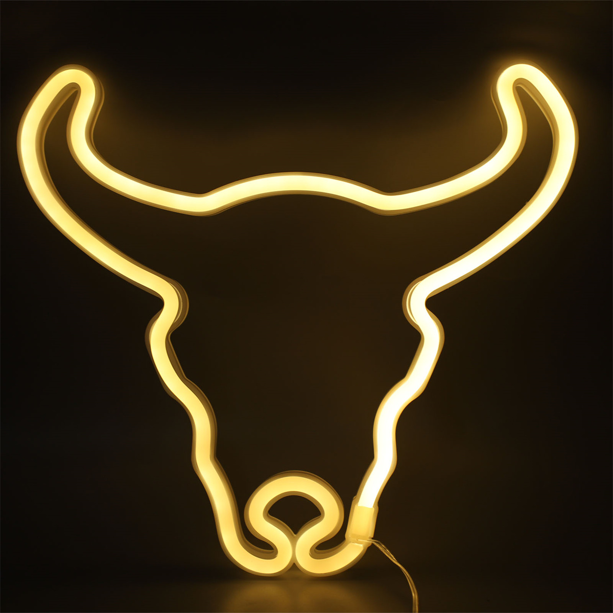Gelbe Neon-Stierkopf-Silhouette auf schwarzem Hintergrund.
