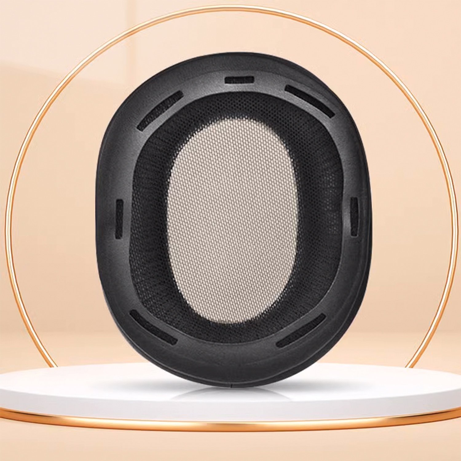 Een zwart oorkussen voor een koptelefoon met mesh, geplaatst op een wit podium met een gouden ring.