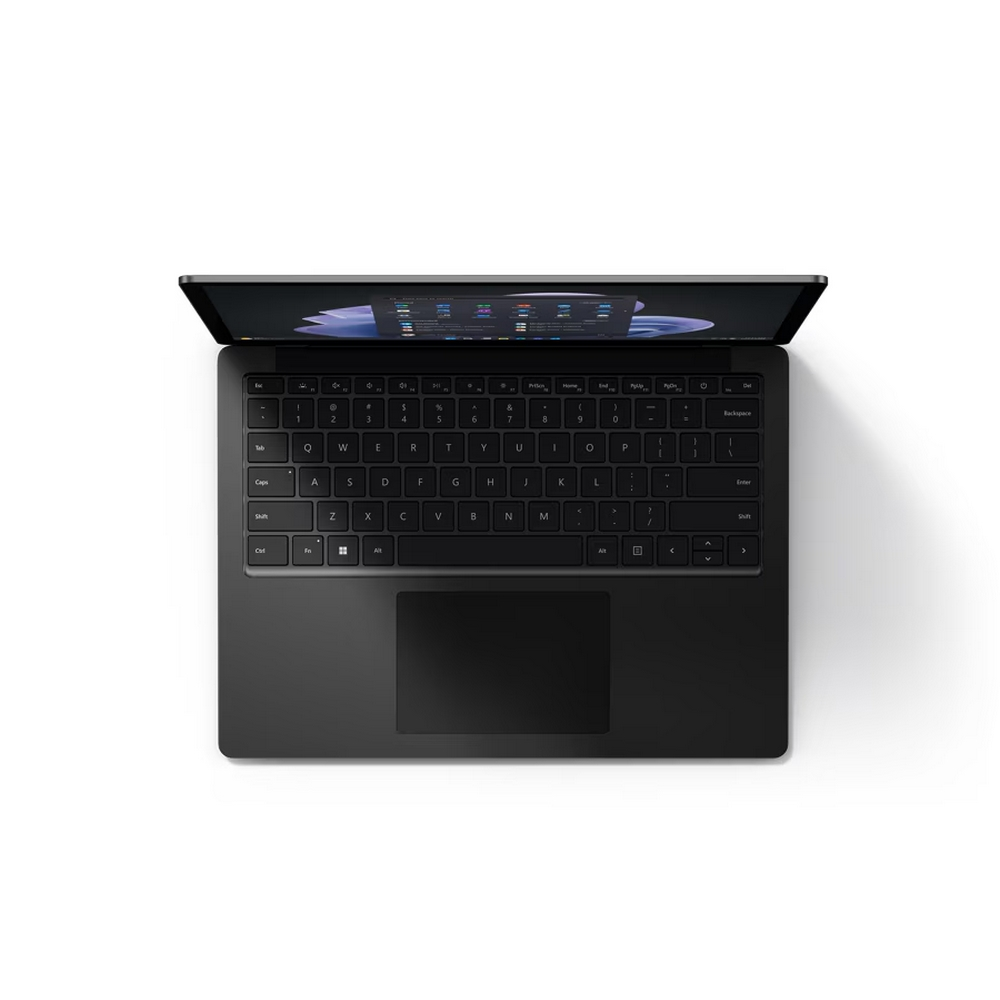 Laptop nero, vista dall'alto, aperto su una superficie bianca. La tastiera e lo schermo sono visibili.