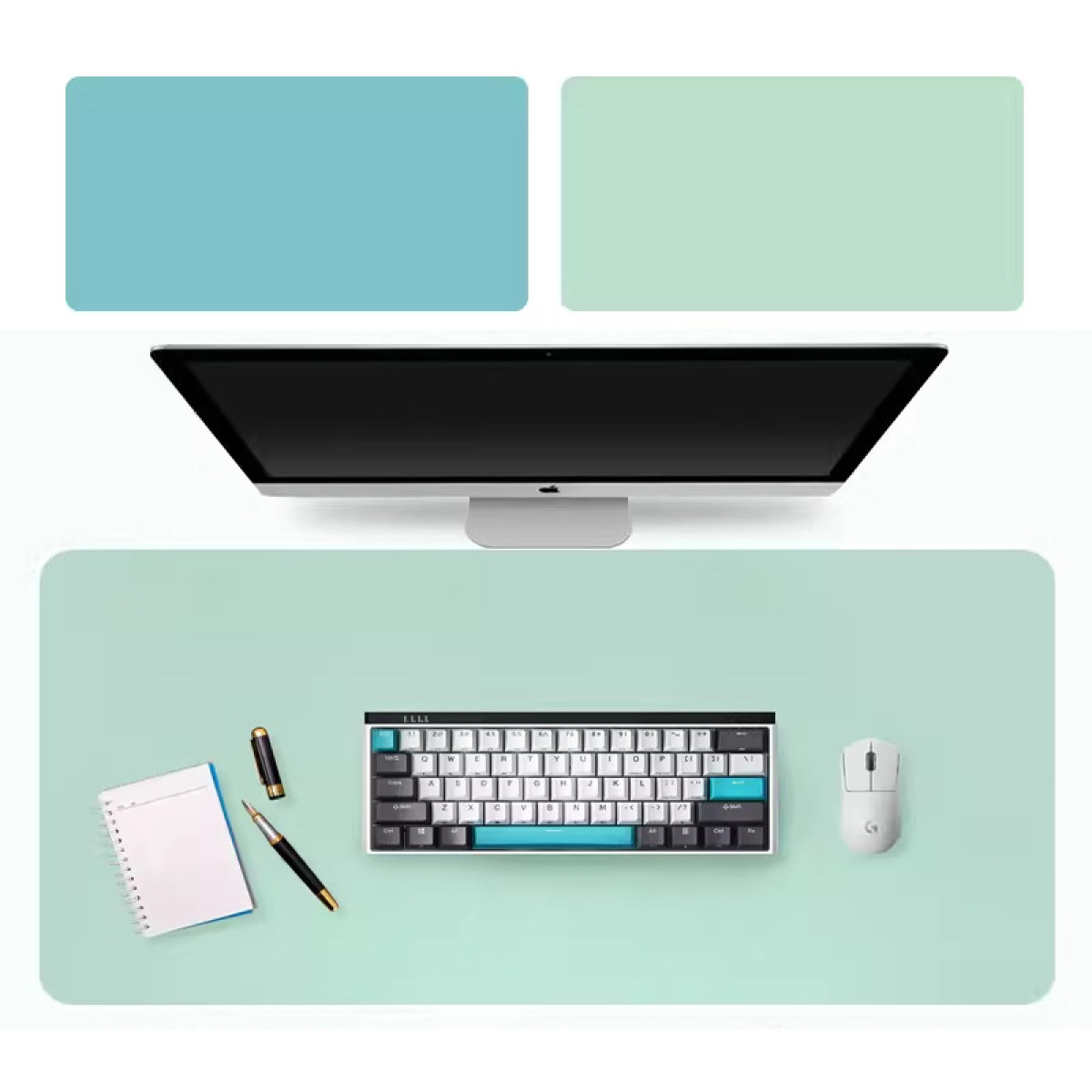 Draufsicht auf Schreibtisch: Monitor, Tastatur, Maus, Notizblock, Stift auf grünem Pad.