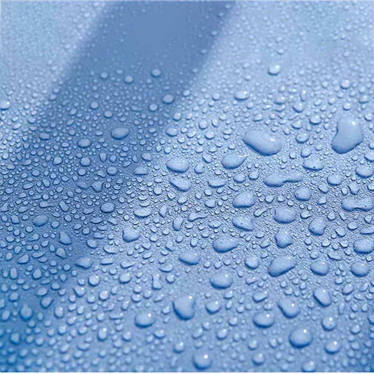 Nahaufnahme von Wassertropfen auf einer blauen Oberfläche. Die Tropfen variieren in Größe und Form.