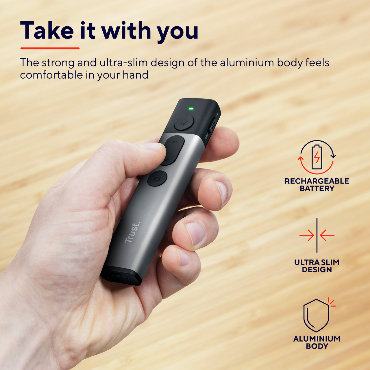 Srebrny i czarny pilot do prezentacji trzymany w dłoni, wraz z ikonami i tekstem.