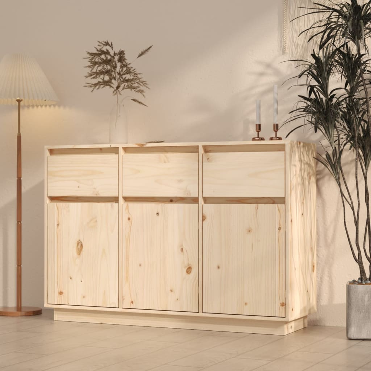 Holzschrank mit drei Türen und Schubladen. Pflanzen und Lampe im Hintergrund.