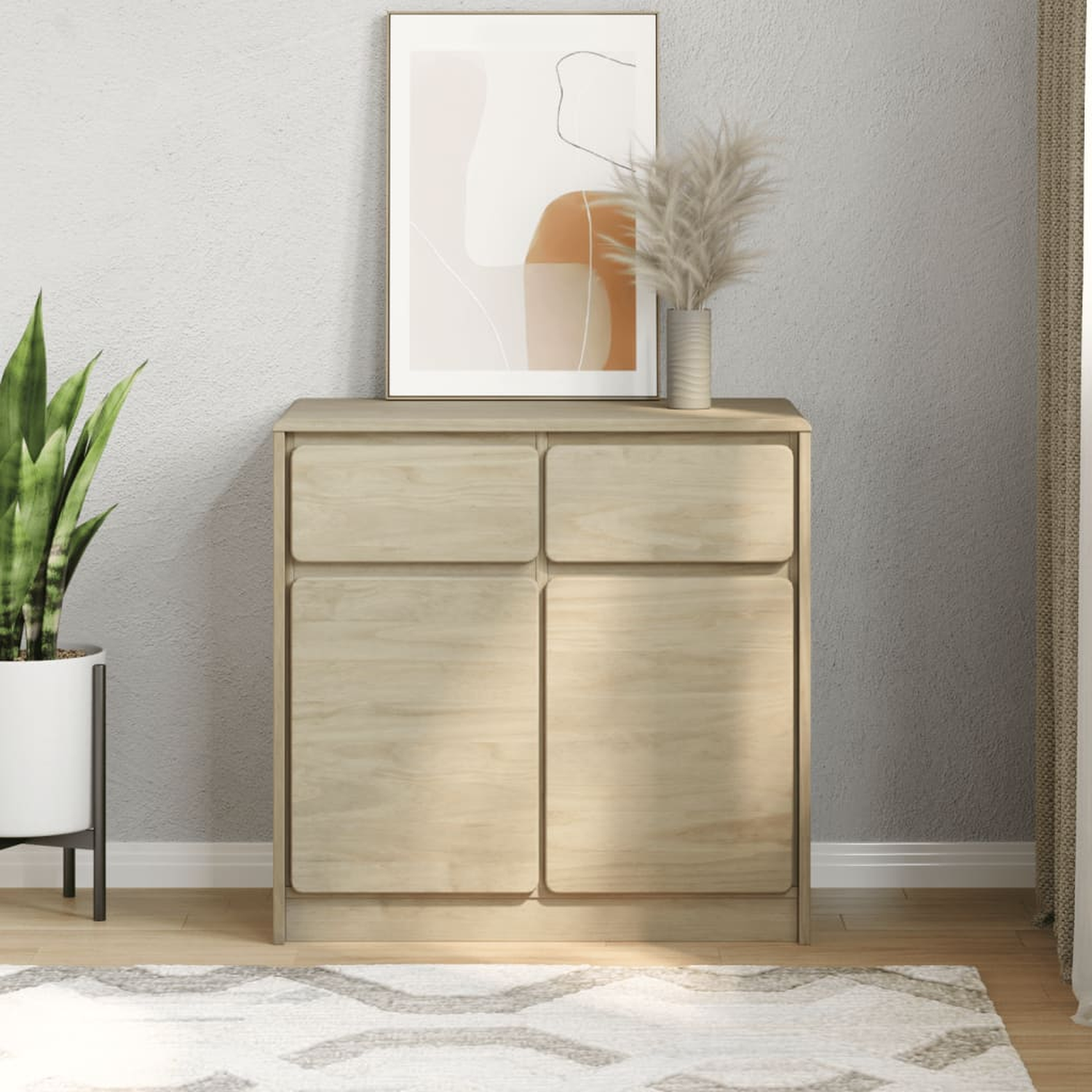 Ein hellbrauner Schrank mit zwei geschlossenen Türen, ein Gemälde und eine Vase oben drauf.
