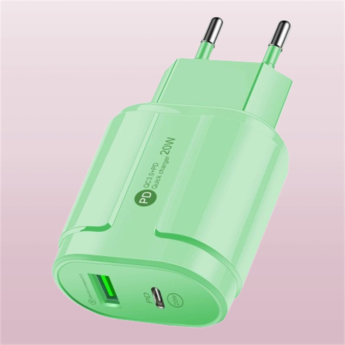 Ein hellgrünes Telefonladegerät mit USB-Anschluss und zwei Stiften, vor einem rosa Hintergrund.