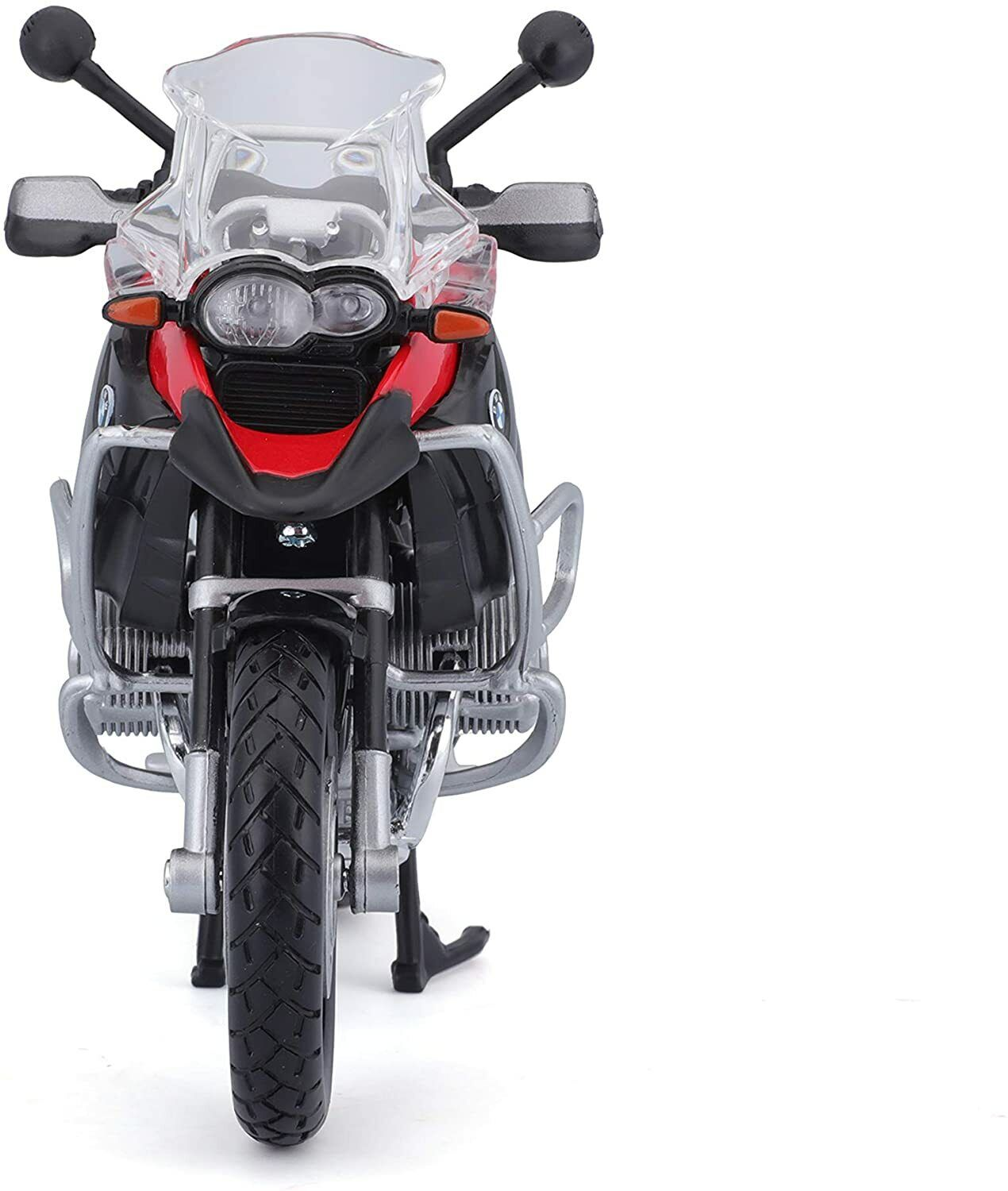 Ein Spielzeugmotorrad, schwarz und rot, mit einer durchsichtigen Windschutzscheibe. Vorderansicht, weißer Hintergrund.