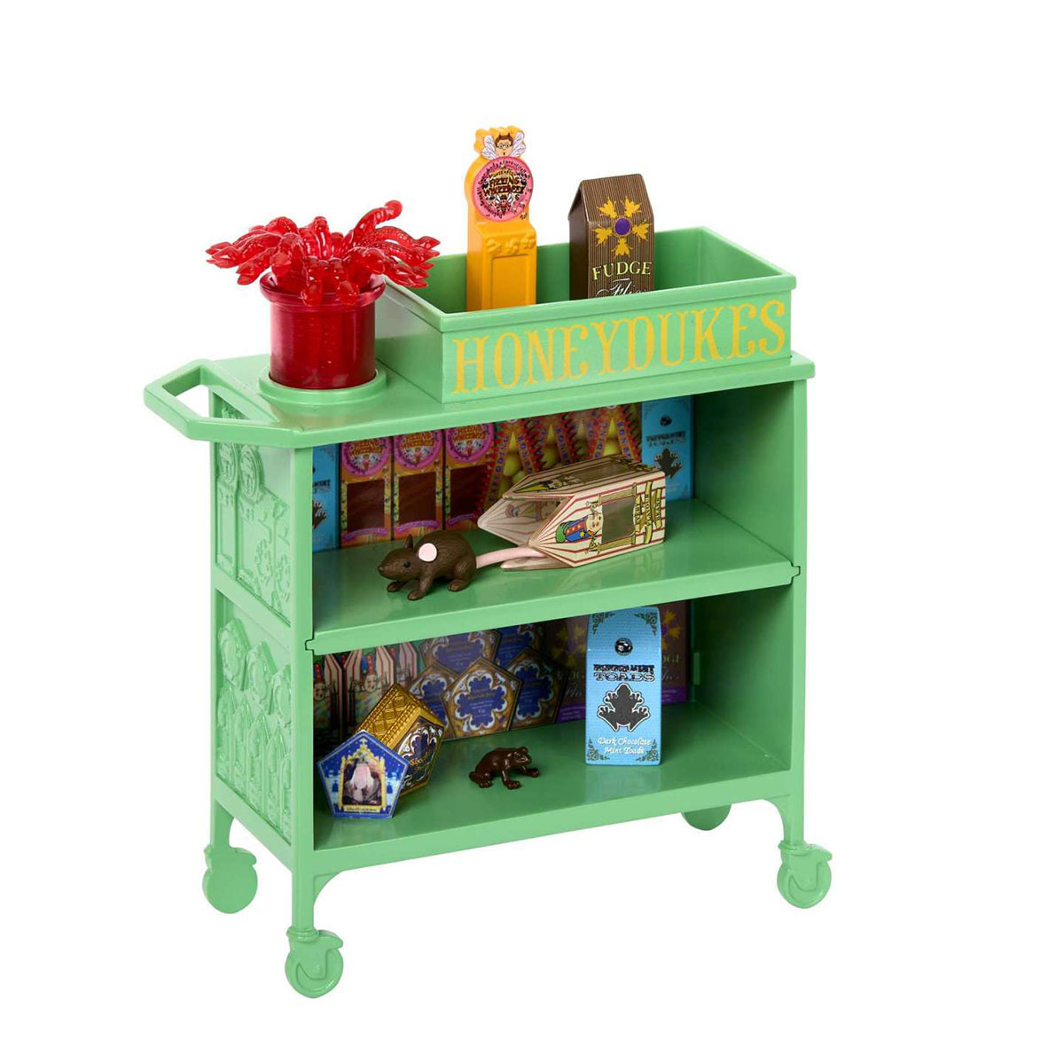 Carrello verde con ripiani. Contiene caramelle, un vaso rosso e un'insegna Honeydukes.