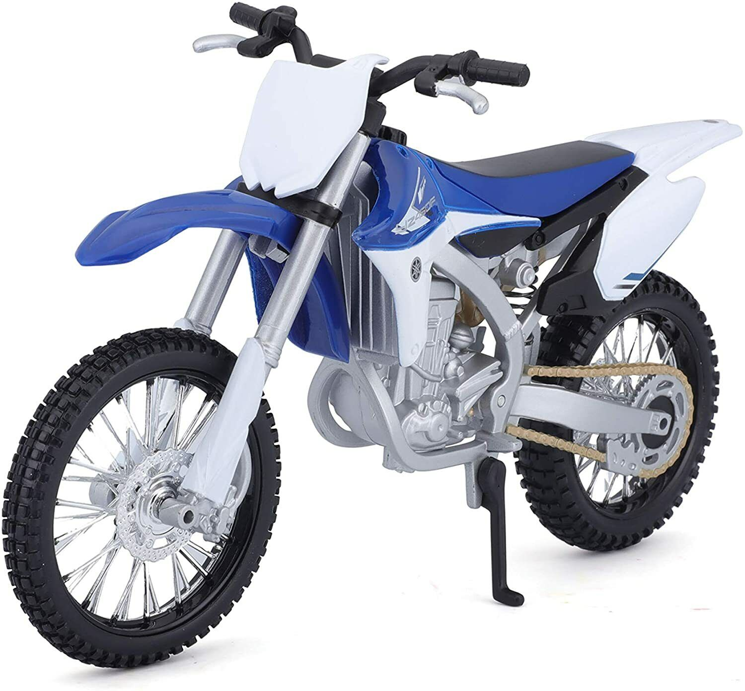 Blaues und weißes Spielzeug-Dirtbike. Es steht auf einer weißen Oberfläche und hat einen.