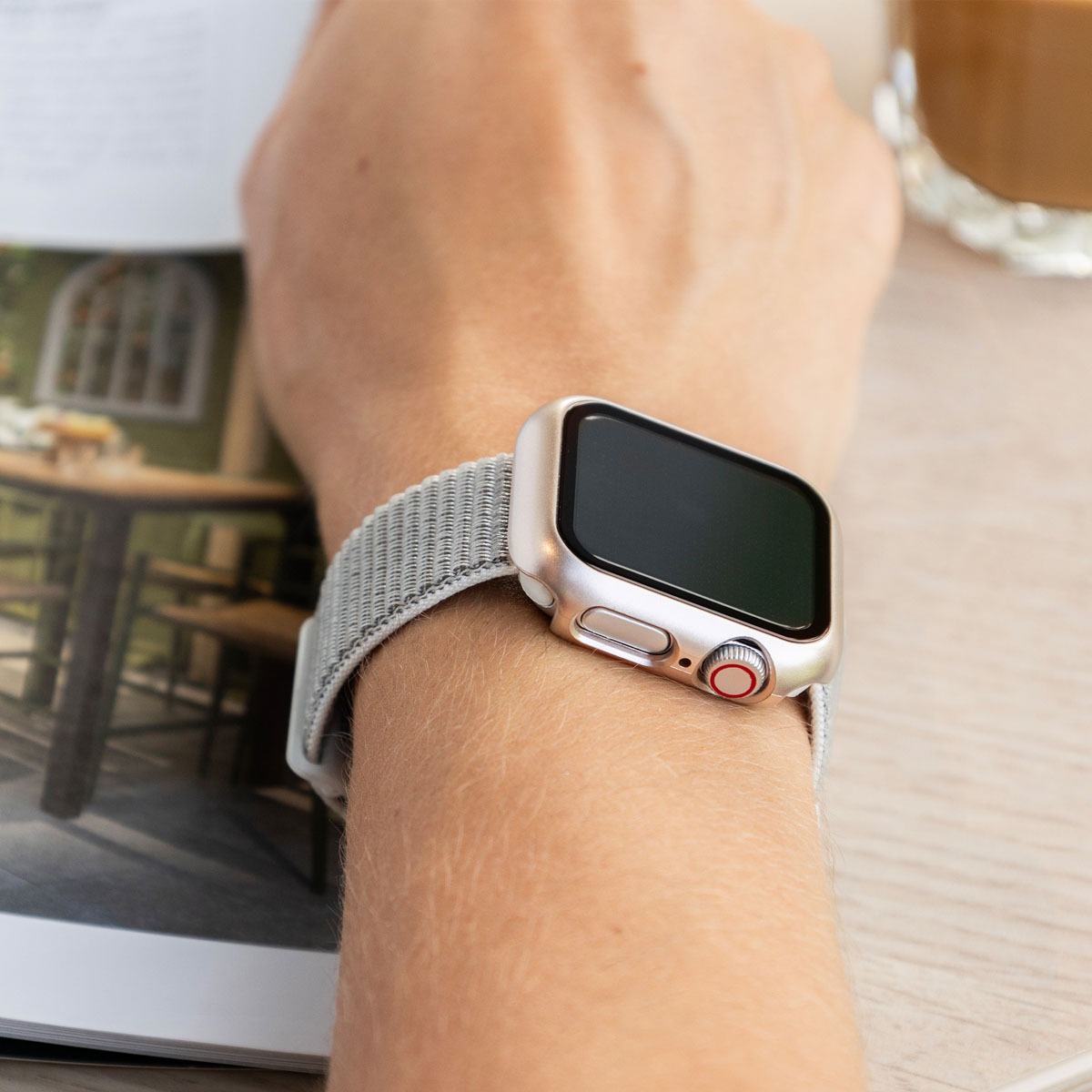 A person wears a watch on their wrist. The watch has a silver case.