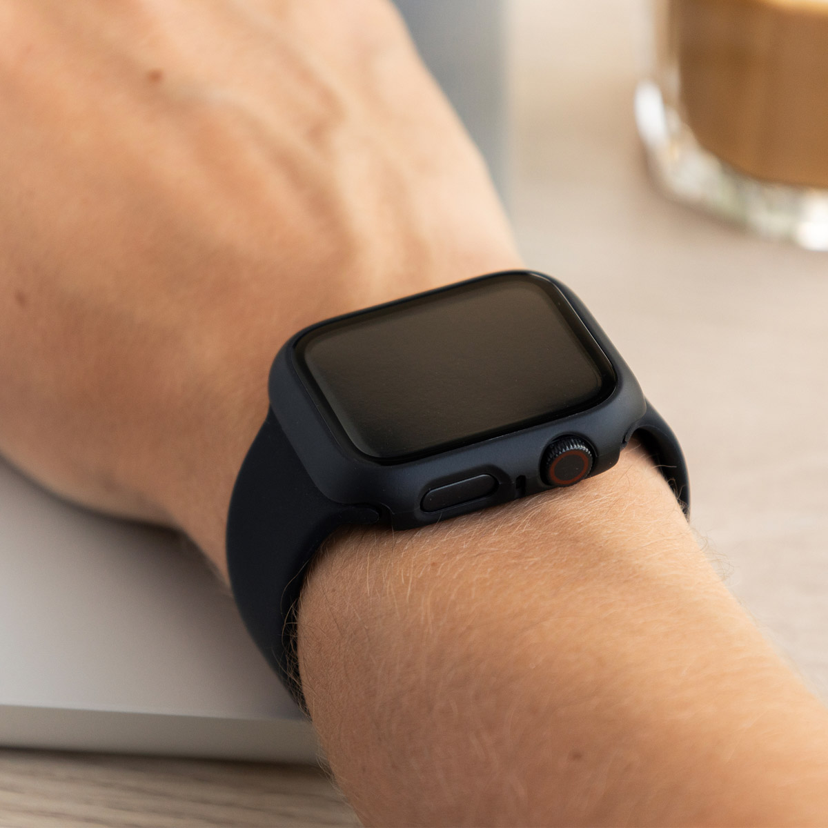 Person wearing a smartwatch. Black band and case. Wrist view.