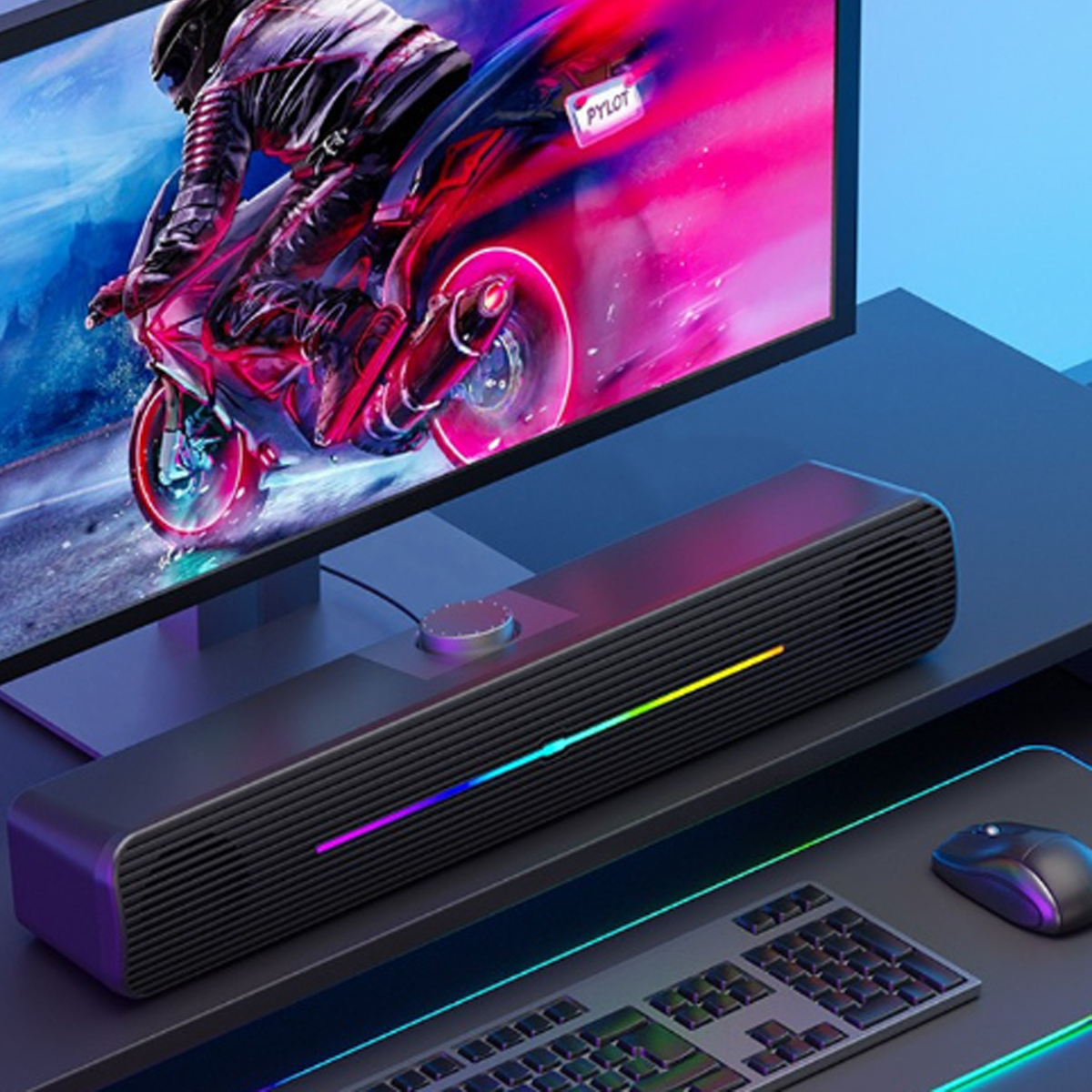 Schwarze Soundbar mit farbigem Lichtstreifen, mit Monitor und Tastatur.