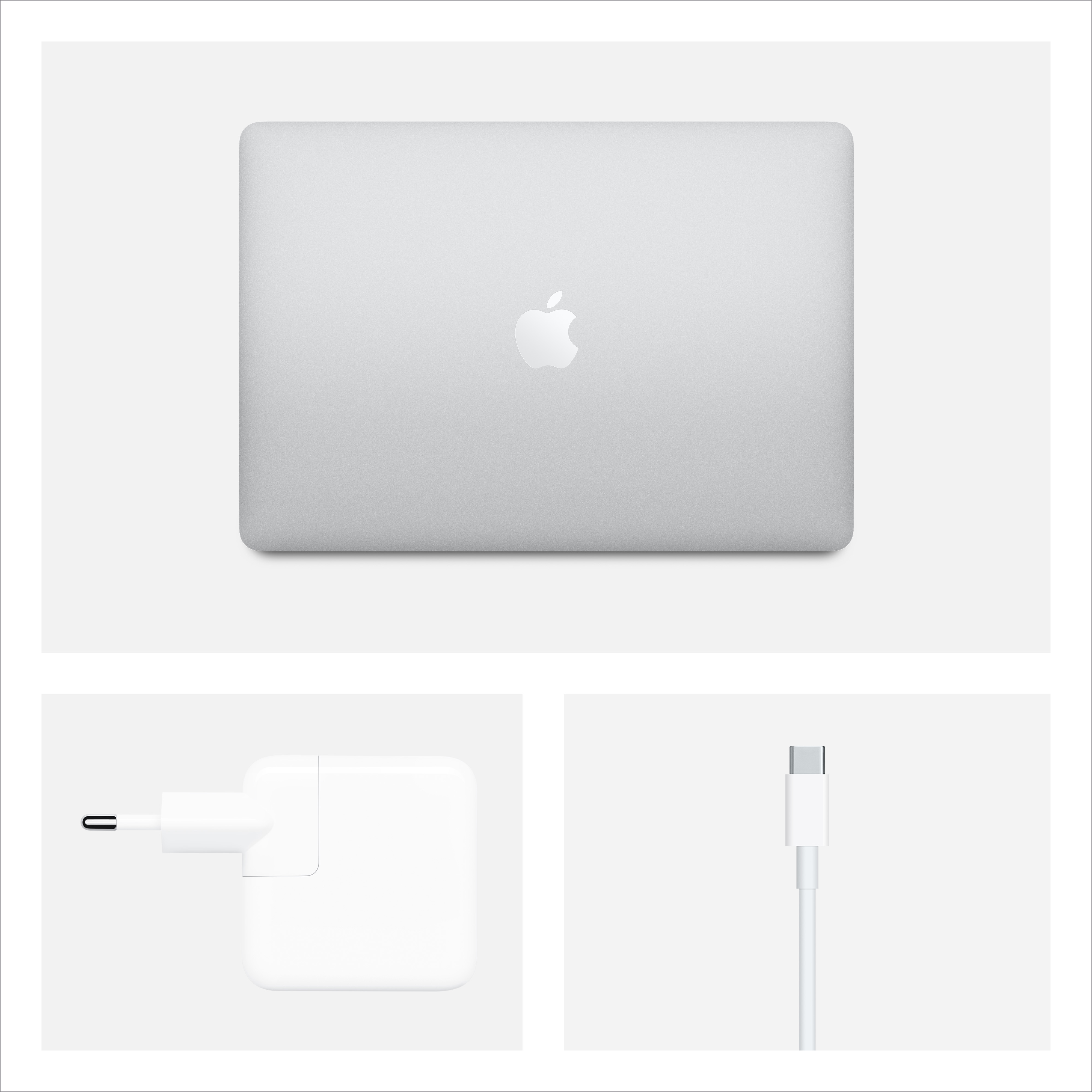 Laptop Apple, chiuso, argento. Sotto, un caricatore e un cavo.