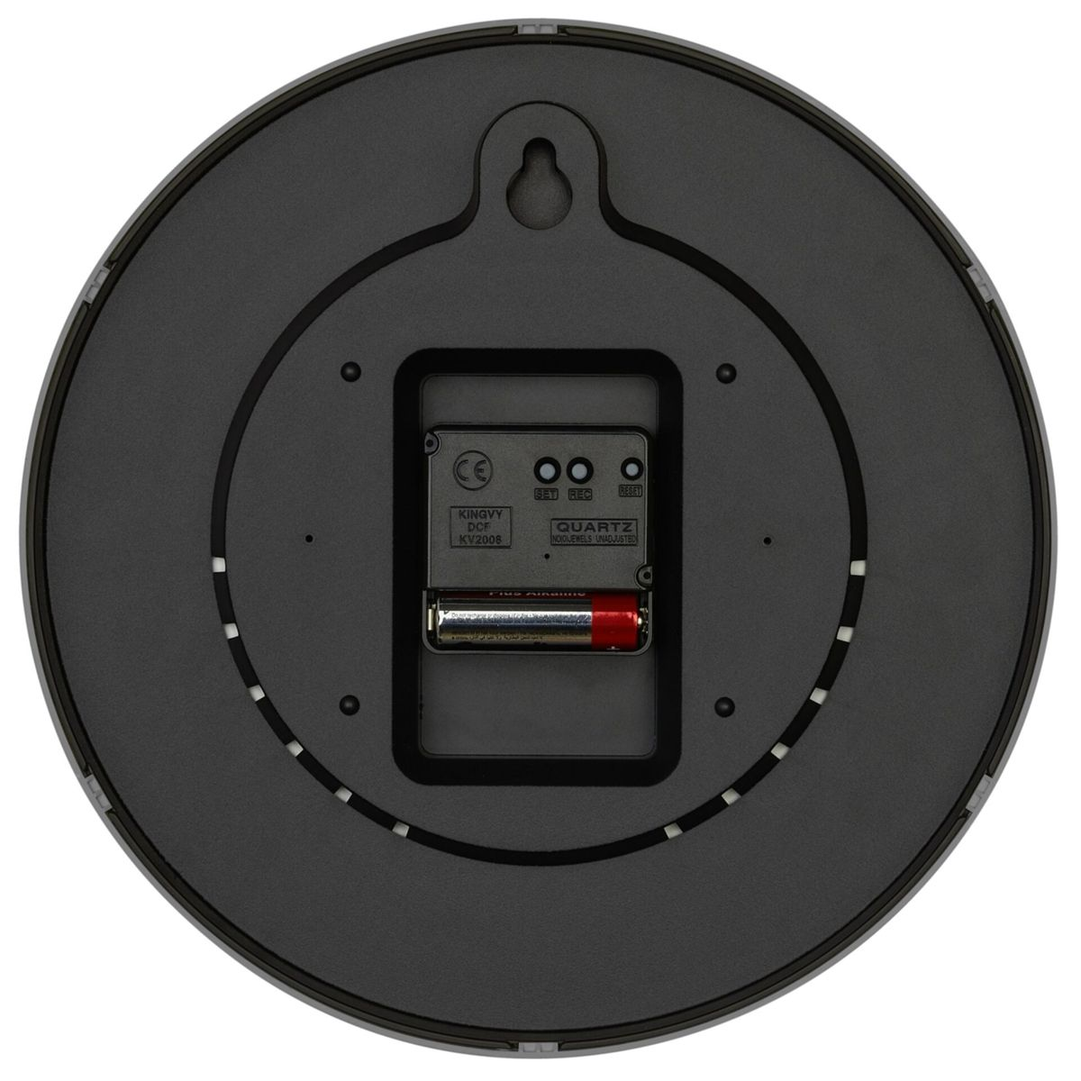 Le dos d'une horloge murale ronde et noire avec le compartiment à piles visible.