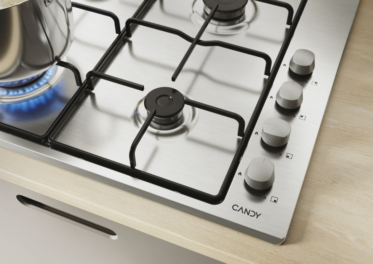 Płyta gazowa ze stali nierdzewnej z czterema palnikami, garnek z jedzeniem po lewej stronie.