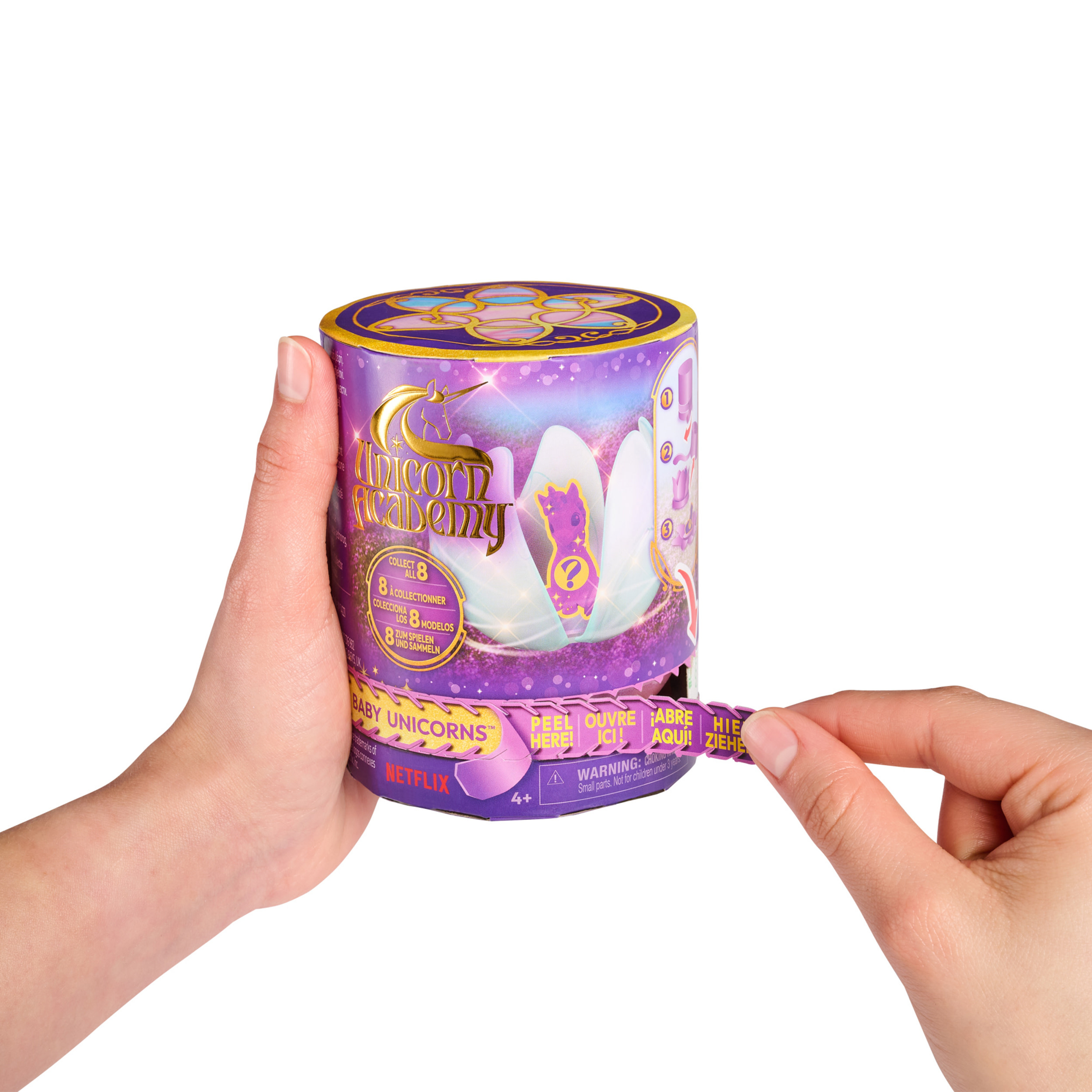 Le mani di una persona che apre un cilindro giocattolo, rivelando un giocattolo all'interno. Tema viola e oro.