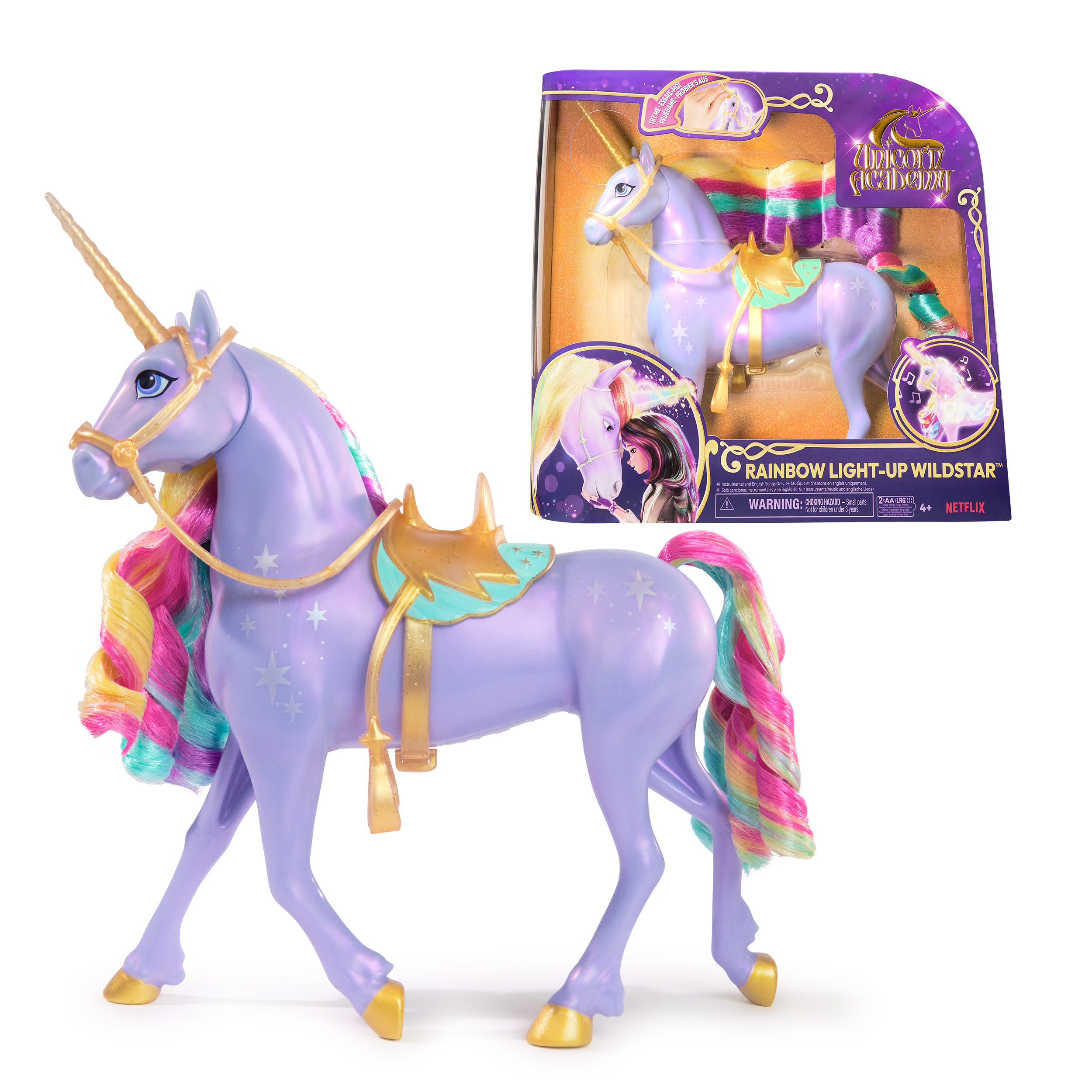 Un unicorno giocattolo con criniera e coda arcobaleno, in una scatola. L'unicorno ha delle stelle.