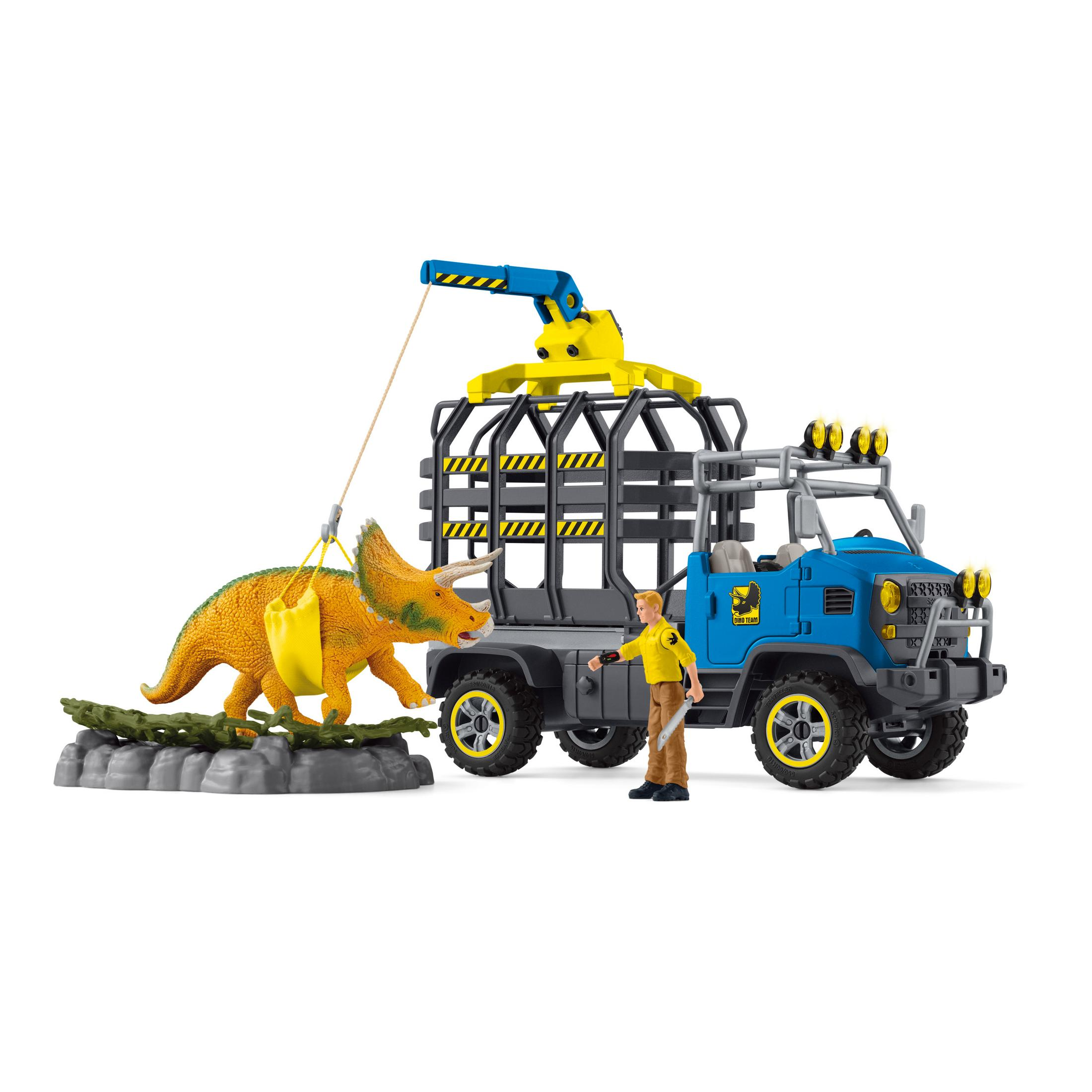 A toy scene of a dinosaur being transported in a truck, with a person nearby.