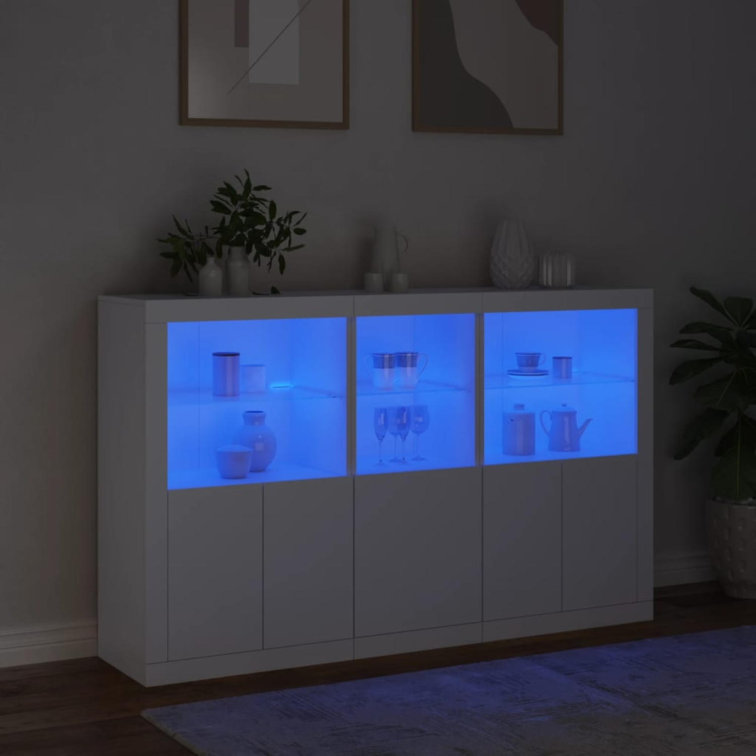 Weißer Schrank mit blauem Licht innen. Es hat drei Abschnitte mit Türen.