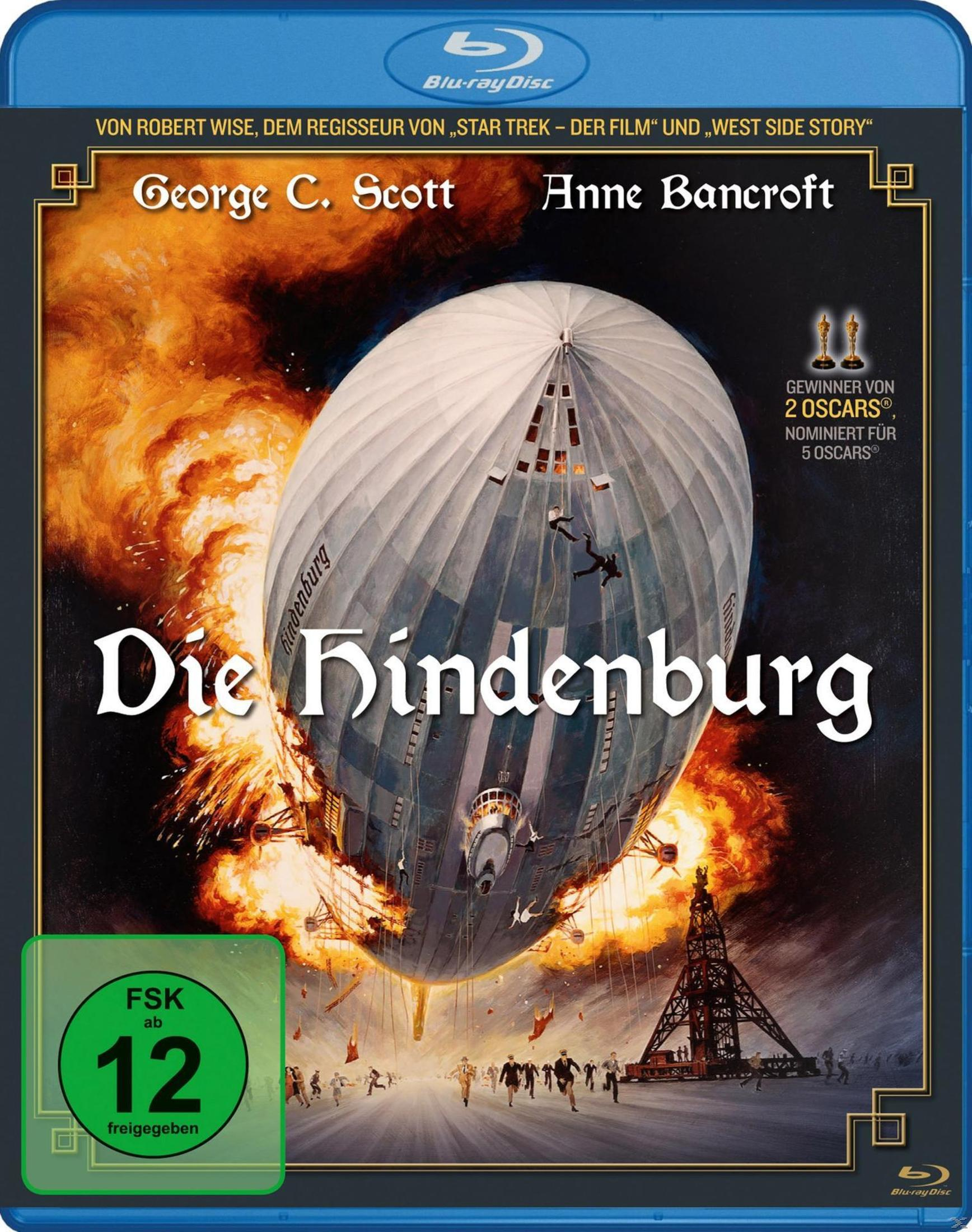 Le dirigeable Hindenburg brûle et s'écrase pendant que des gens fuient.