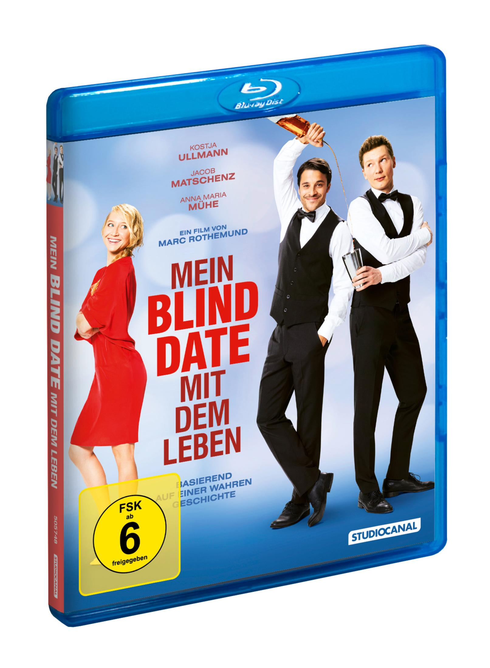 Une jaquette Blu-ray avec deux hommes en gilet et une femme en robe rouge.