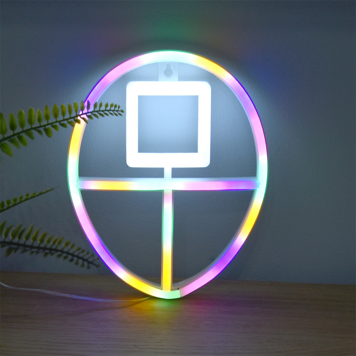 Neonschild in Form eines Kreises, Quadrats und Kreuzes.