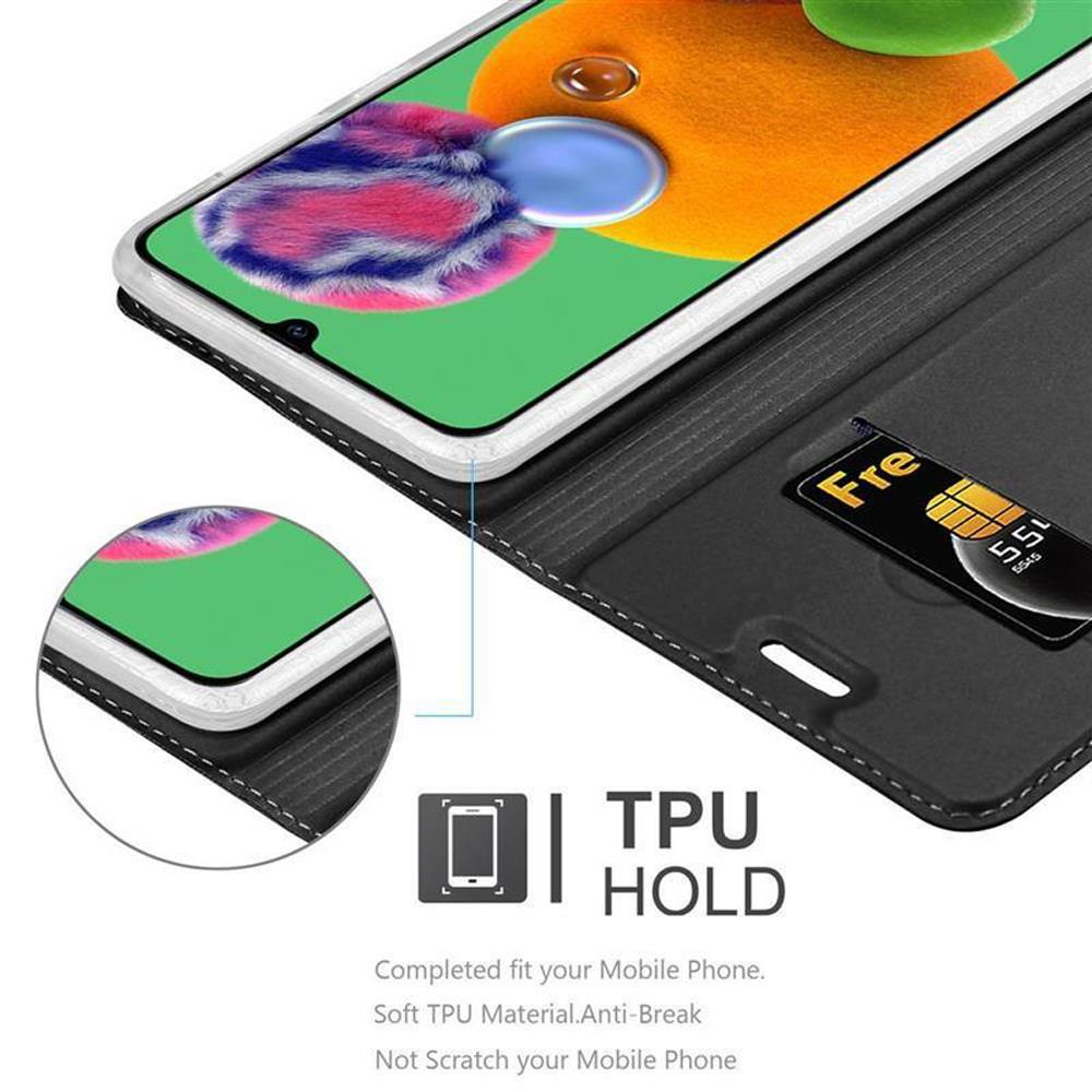 Primo piano di un telefono in una custodia con SIM card visibile e la scritta 'TPU HOLD'.