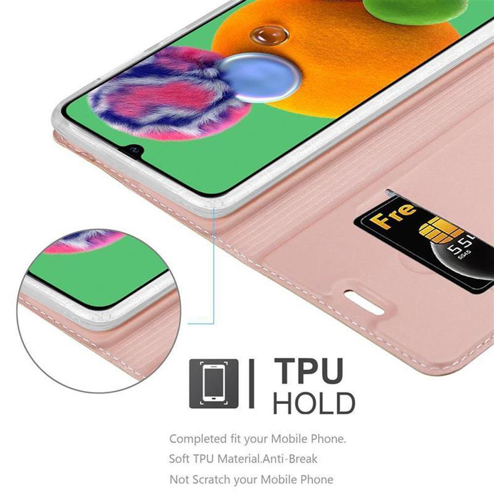 Telefono con custodia rosa, con carta nello slot. Testo: TPU HOLD.