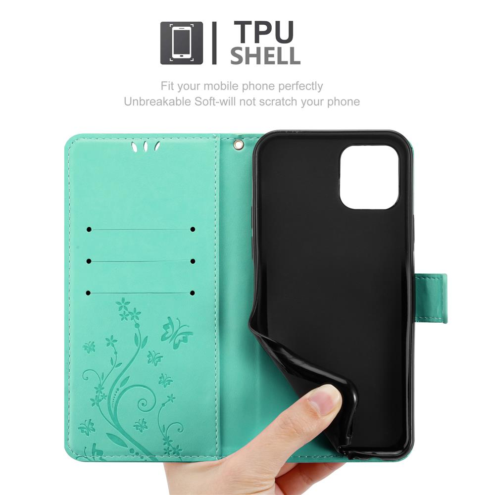 Una custodia per telefono aperta con una cover verde acqua e interno nero. Una mano tiene la cover.