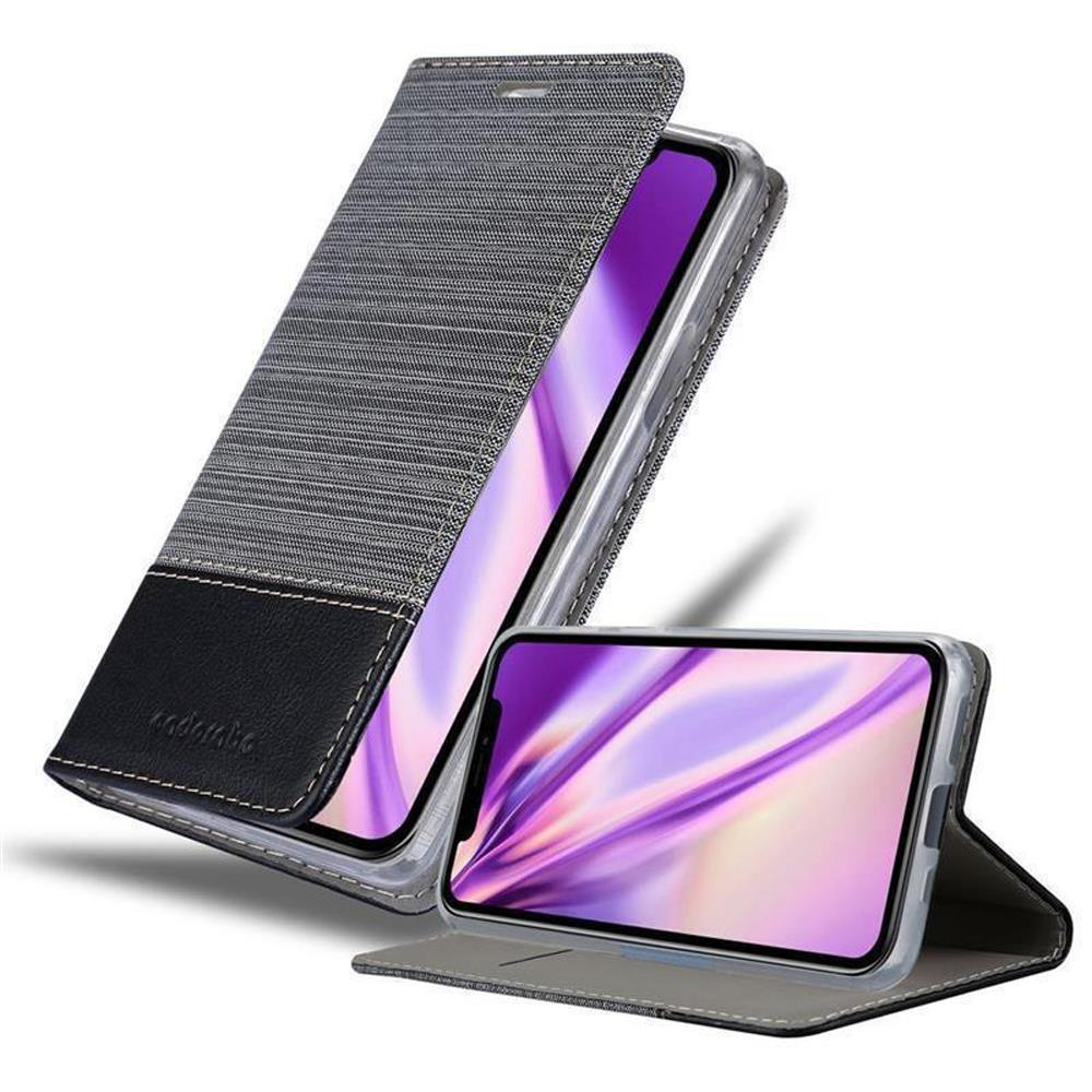 Telefono nella custodia, aperto, mostra schermo, sfondo grigio.