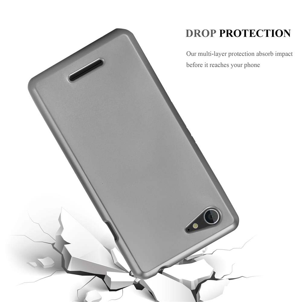 Funda plateada para teléfono con grietas. La funda está sobre una superficie agrietada, mostrando protección contra caídas.