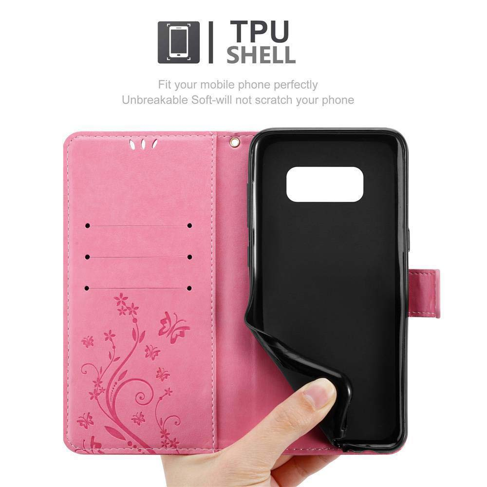 Custodia per telefono rosa, aperta. Telefono dentro. Interno con disegni floreali, con il telefono contro il nero.