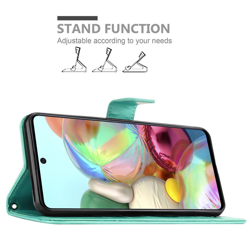 Un telefono in una custodia verde acqua è appoggiato. Lo schermo mostra un design astratto colorato.